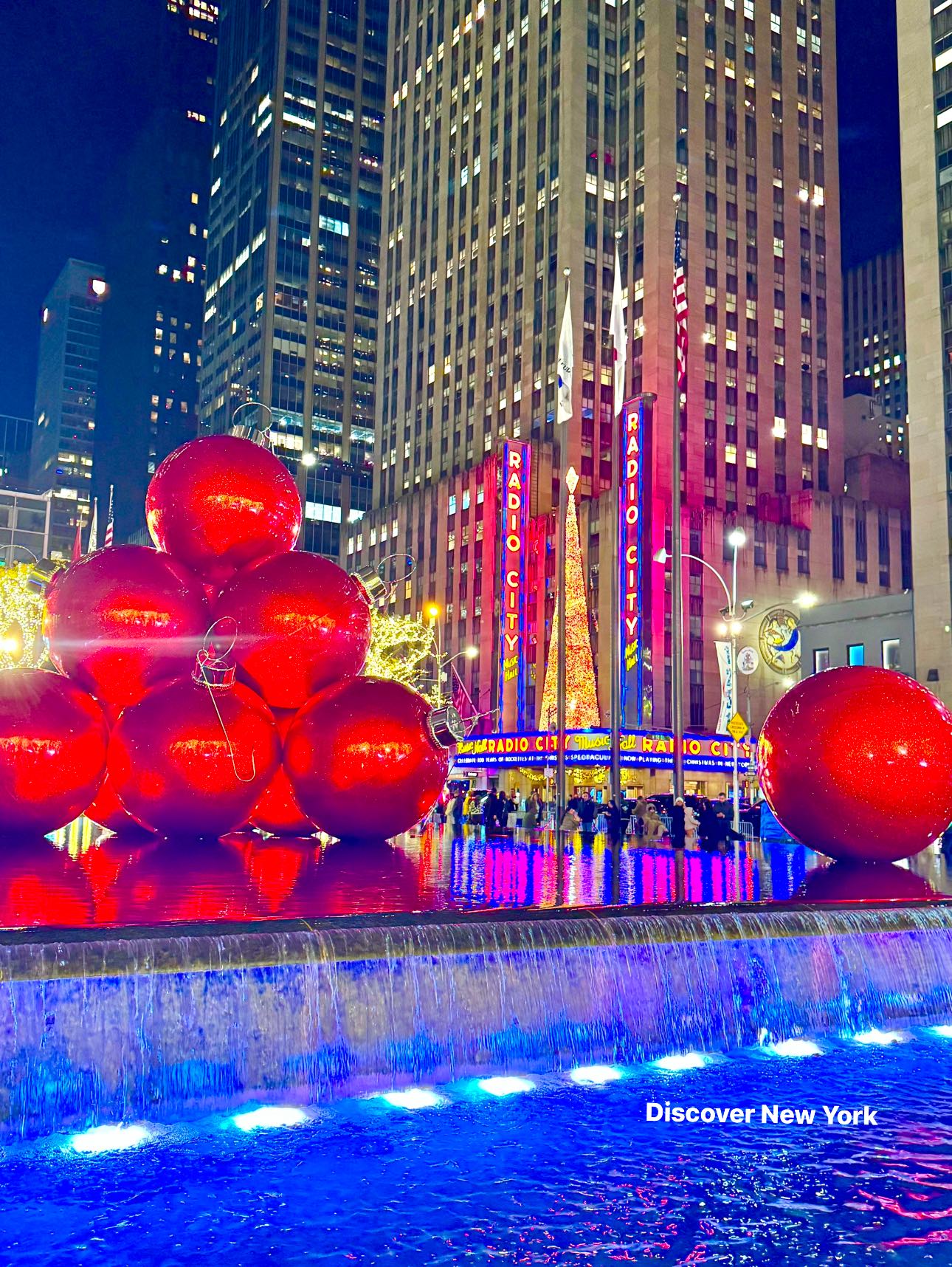 The red ornaments are a set of giant Christmas ornaments displayed 