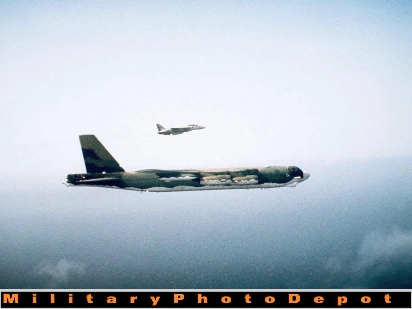An air-to-air right side view of a US Navy F-14A Tomcat aircraft