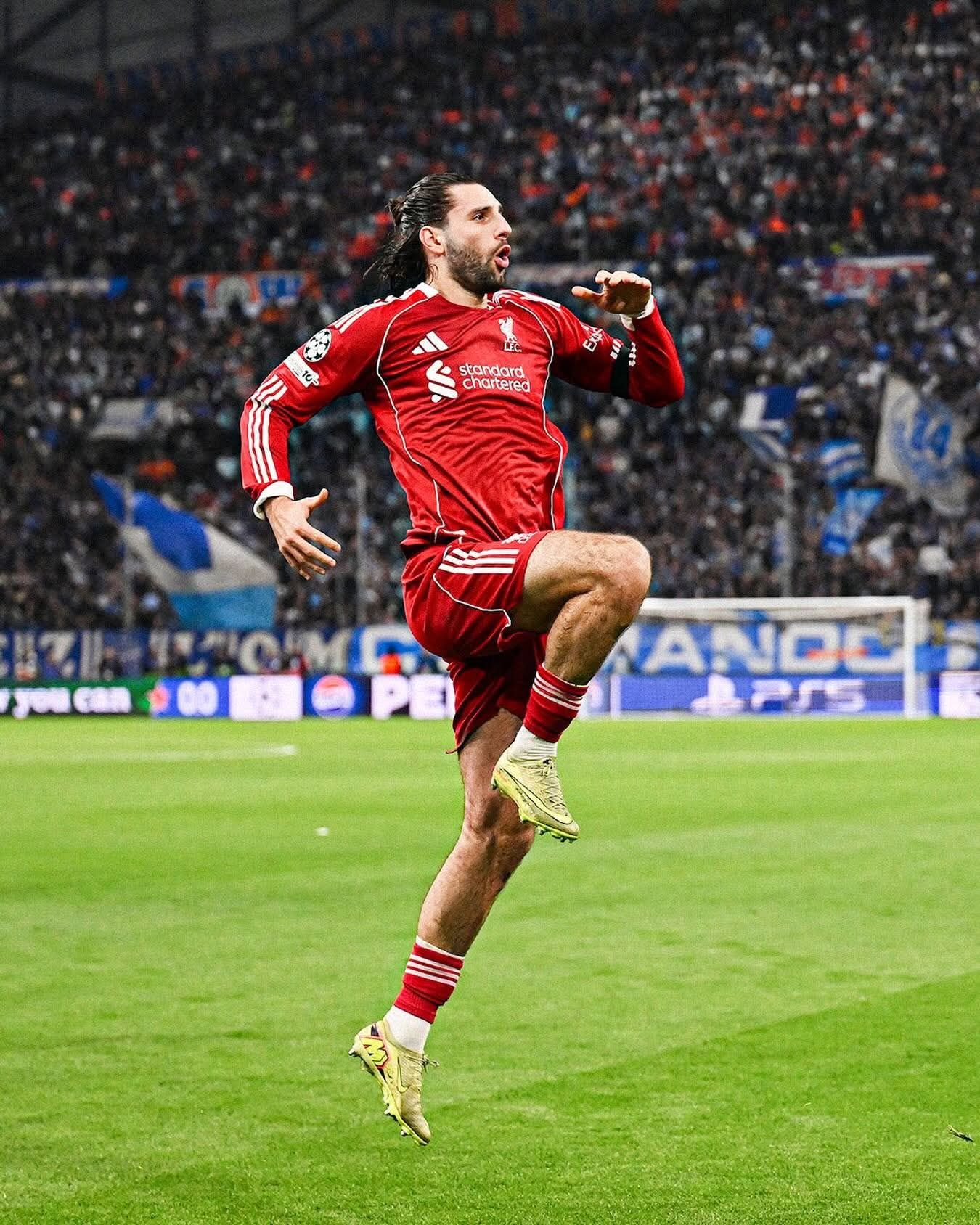 Dominik Szoboszlai #8 with long hair, in red adidas kit.