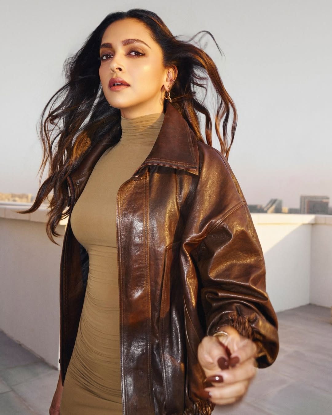 🔗: https://vogueindia.visitlink.me/izgAxj Deepika Padukone pairs a ruched maxi dress with a lived-in leather jacket for the Abu Dhabi Grand Prix
