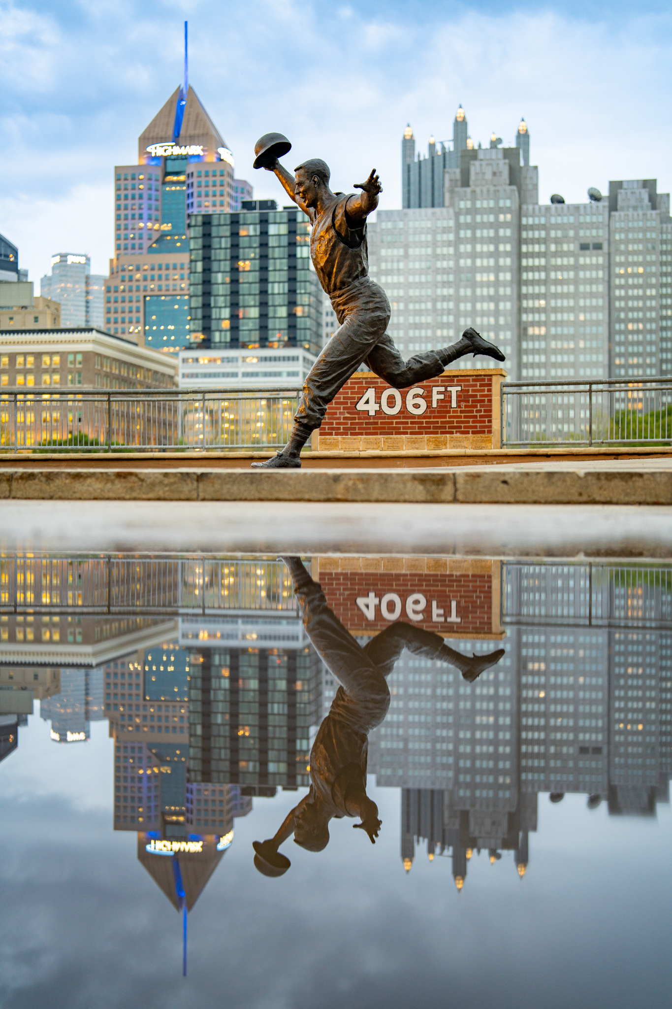 The Bill Mazeroski statue reflects in a puddle last night in