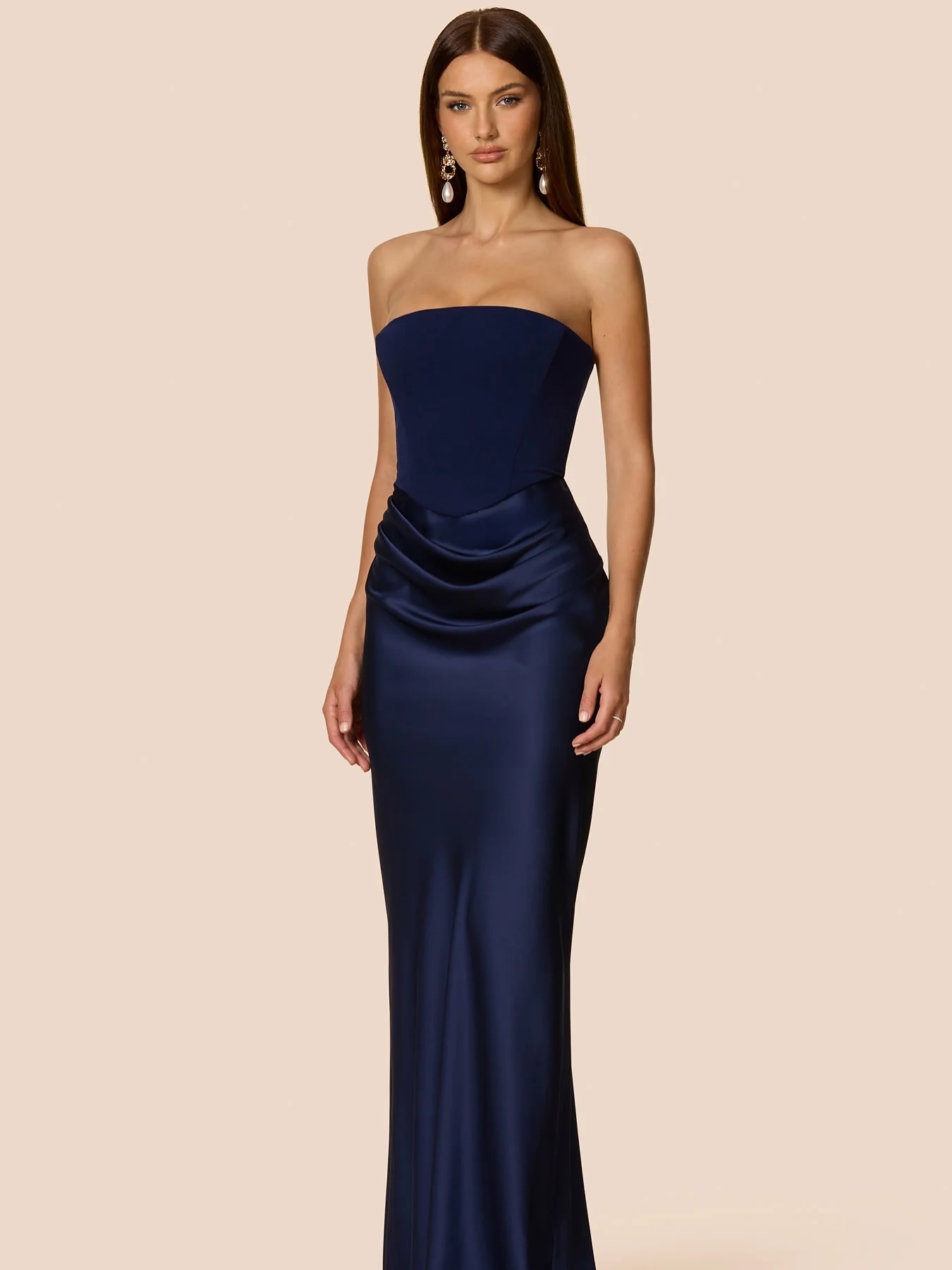 Meet the Chiara gown she is a show-stopping ensemble featuring a structured navy blue corset that sculpts the silhouette, paired with a sleek, fitted satin skirt that glides effortlessly with every step