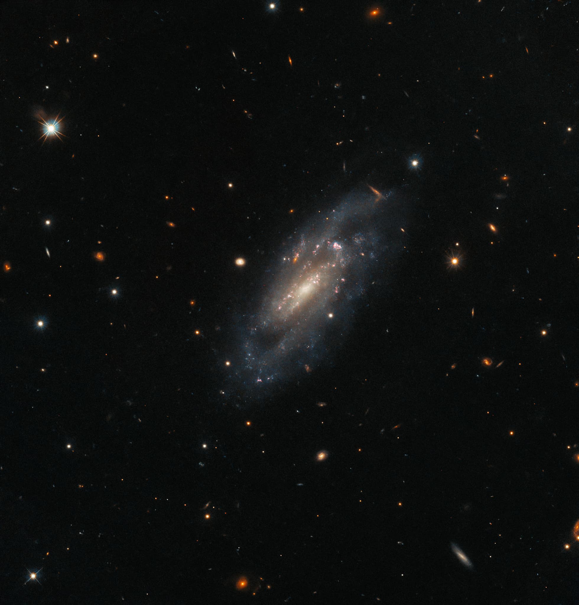 Cosmic fireworks, 60 million light-years away! 💥 NASA's Hubble