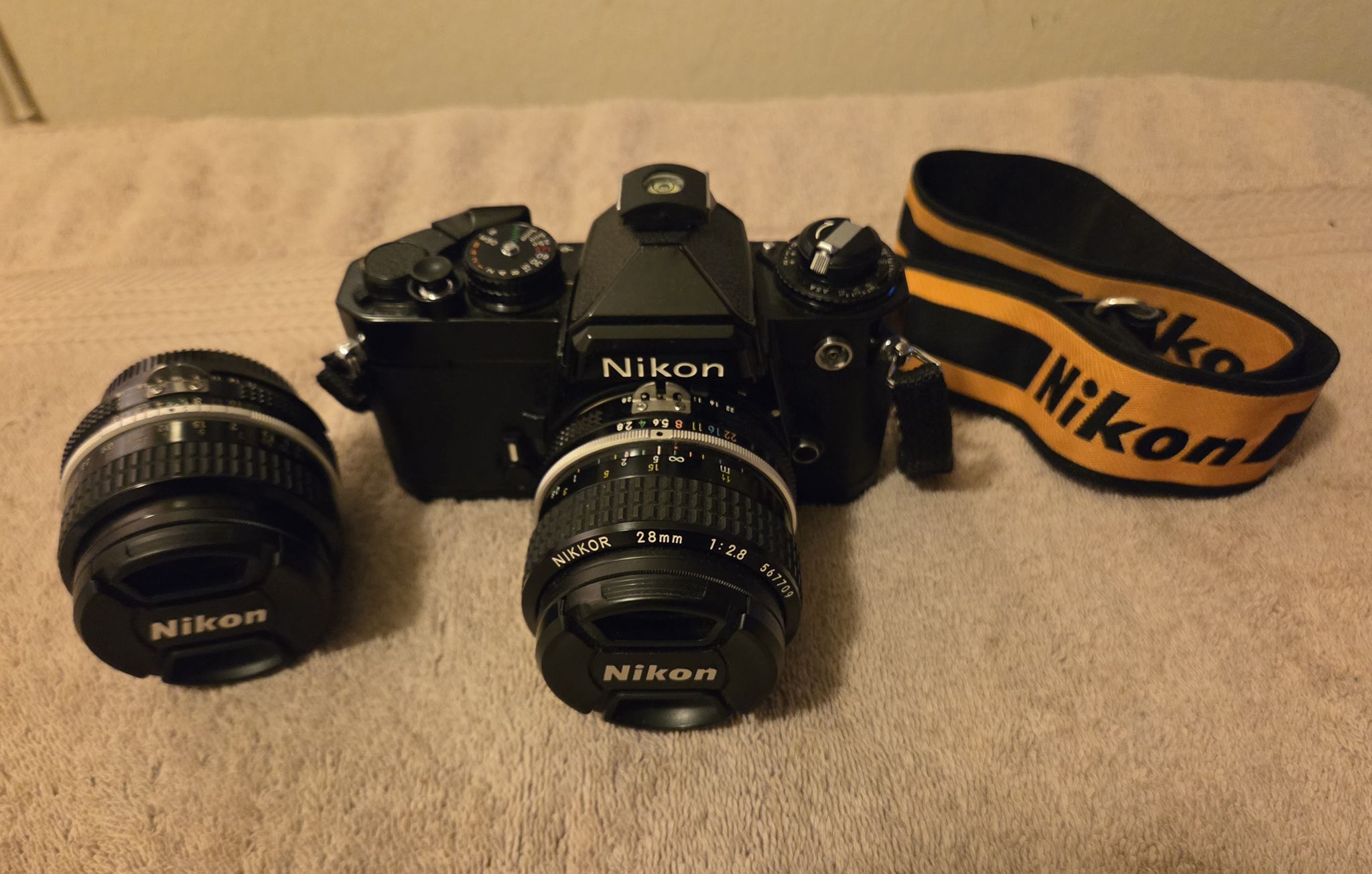 What zoom lens to pair with Nikon FE and 28mm f2.8 AI and 50mm f1 