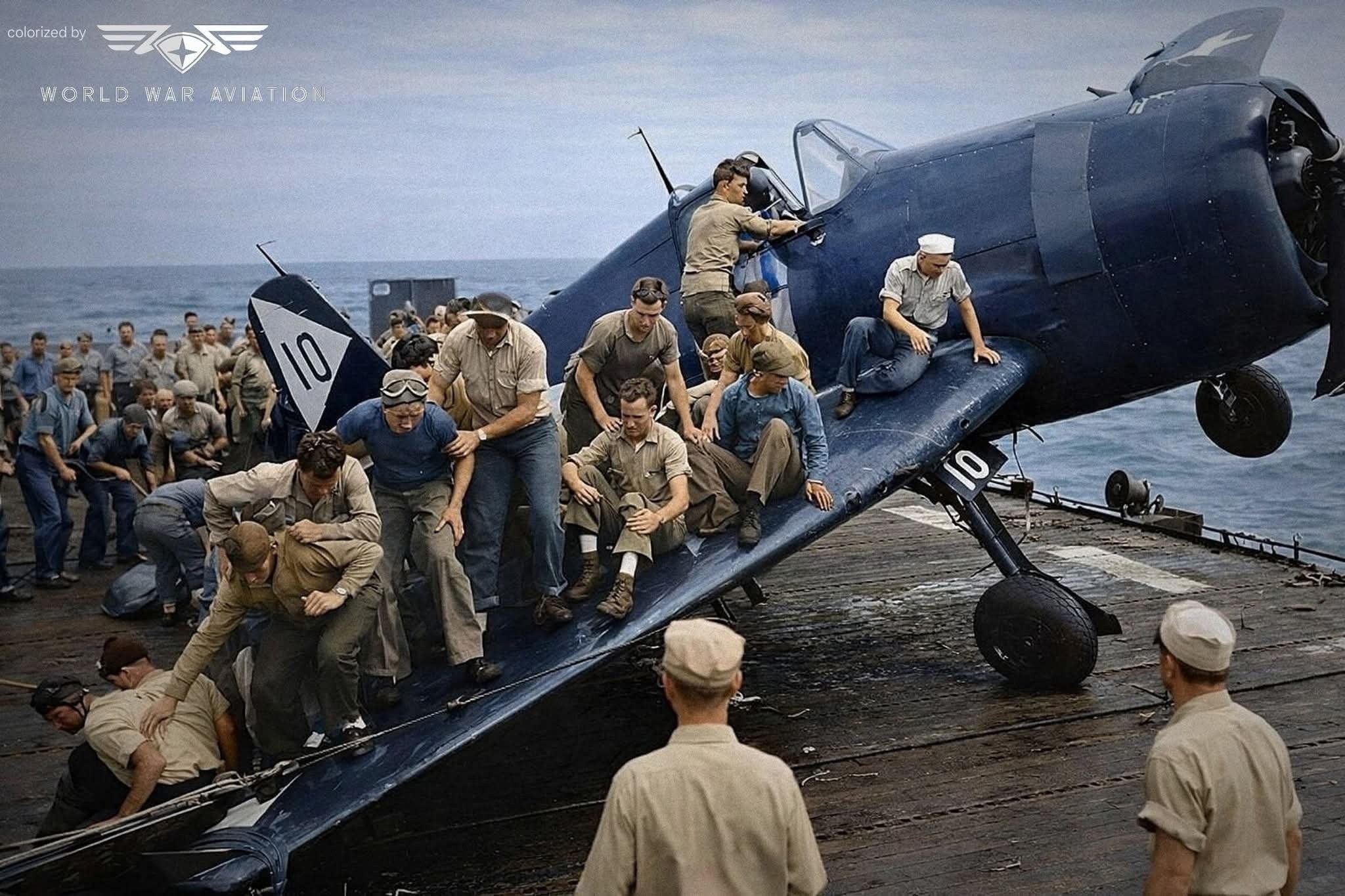Crewmen of the USS Monterey on the starboard wing of an F6F-5