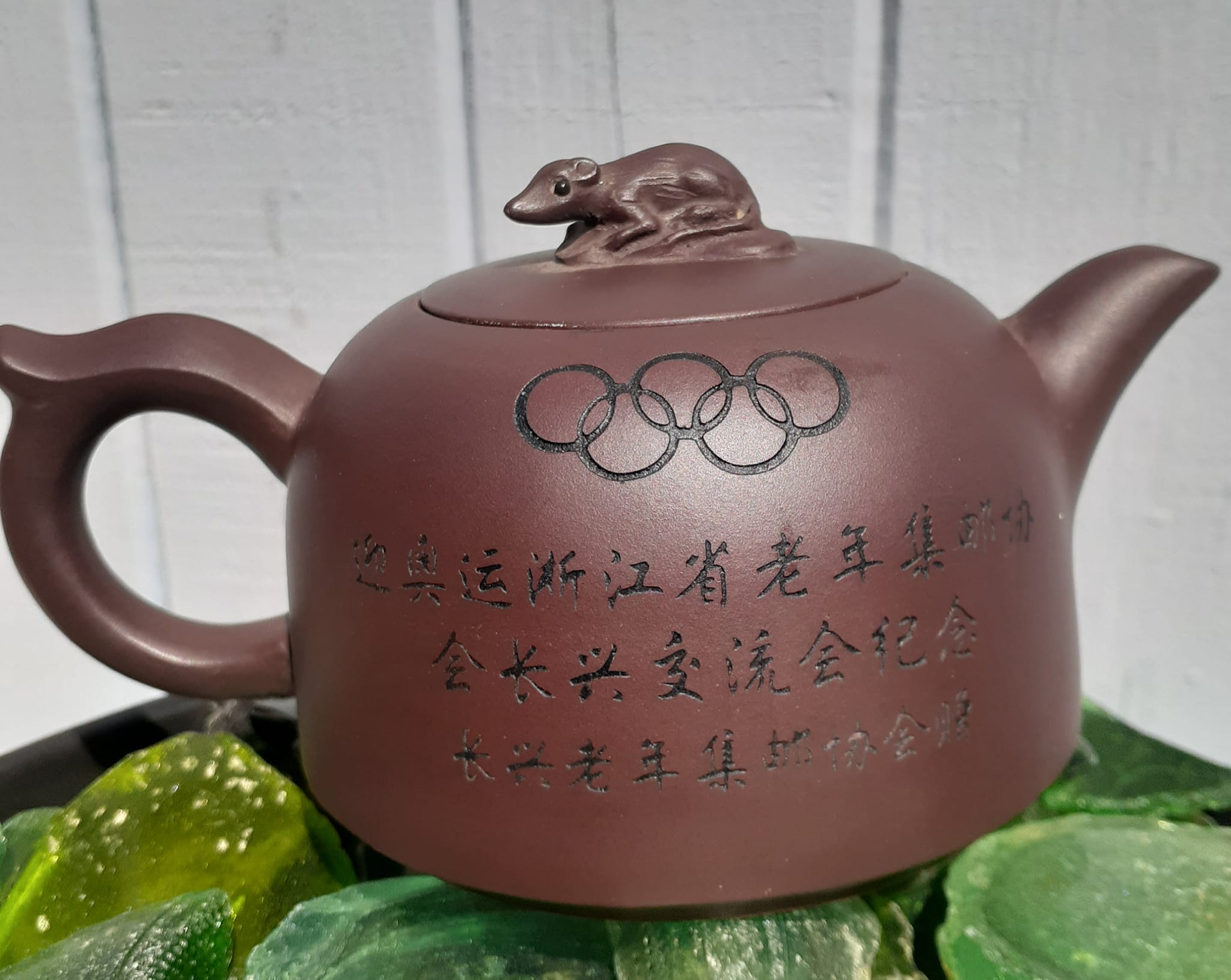What is the story behind this Olympic commemorative teapot with a