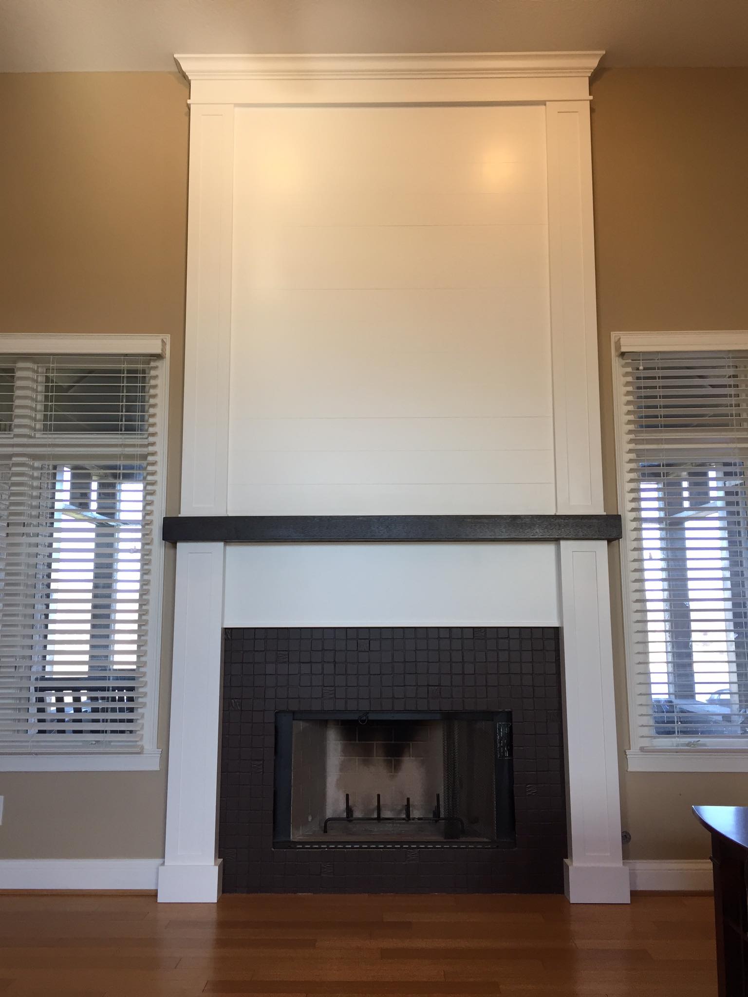 Carpentry Plus - Fireplace facade with dark stained 'beam'...