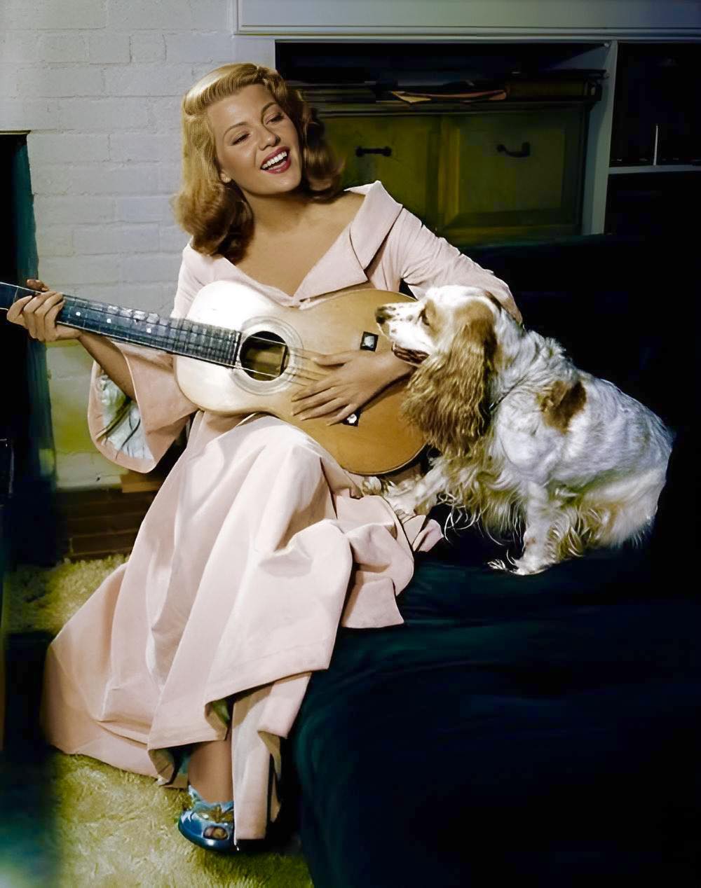 Rita Hayworth in 1948 with guitar and dog