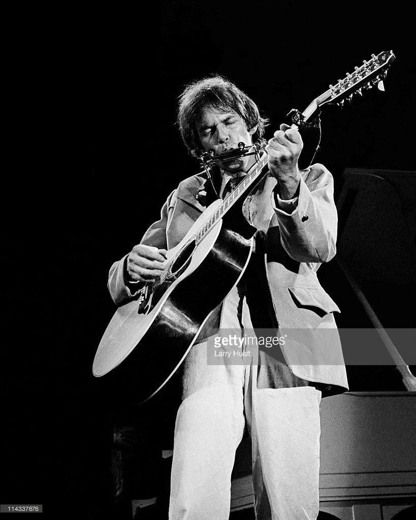 Neil Young performs with his band The Stray Gators at the Forum on