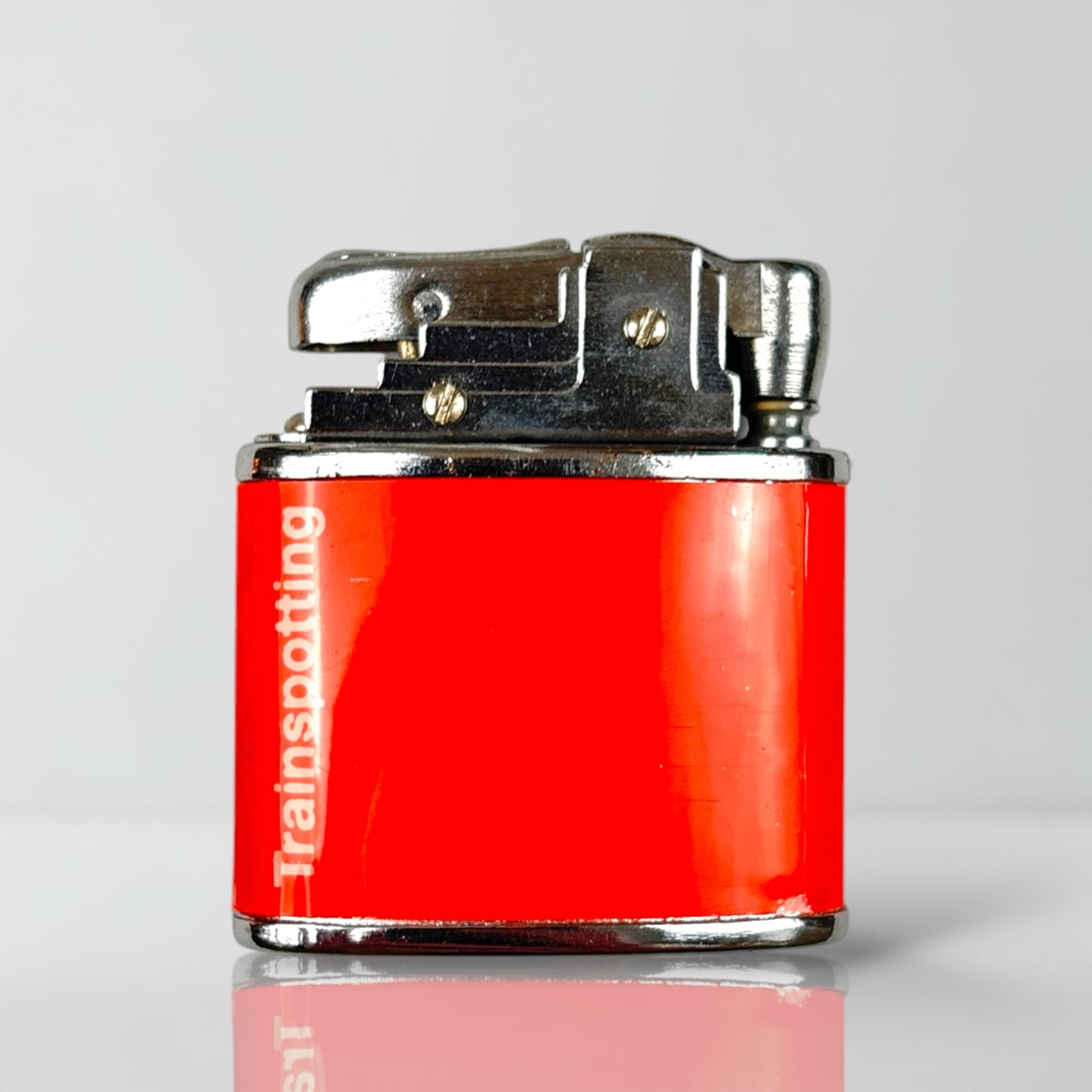 1996 Trainspotting Orange Lighter and Chrome Leaf Case. Available
