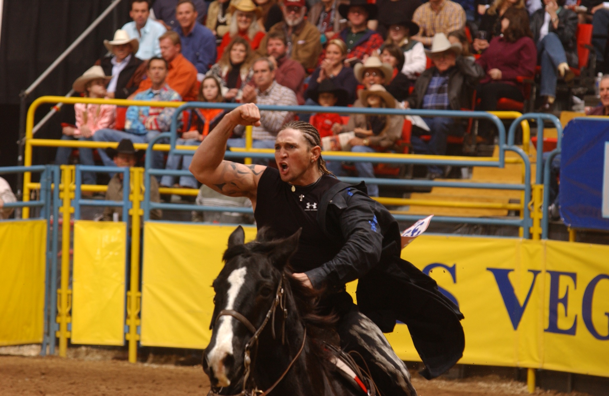 Super Sid Steiner flexing during his victory lap at the 2002 NFR