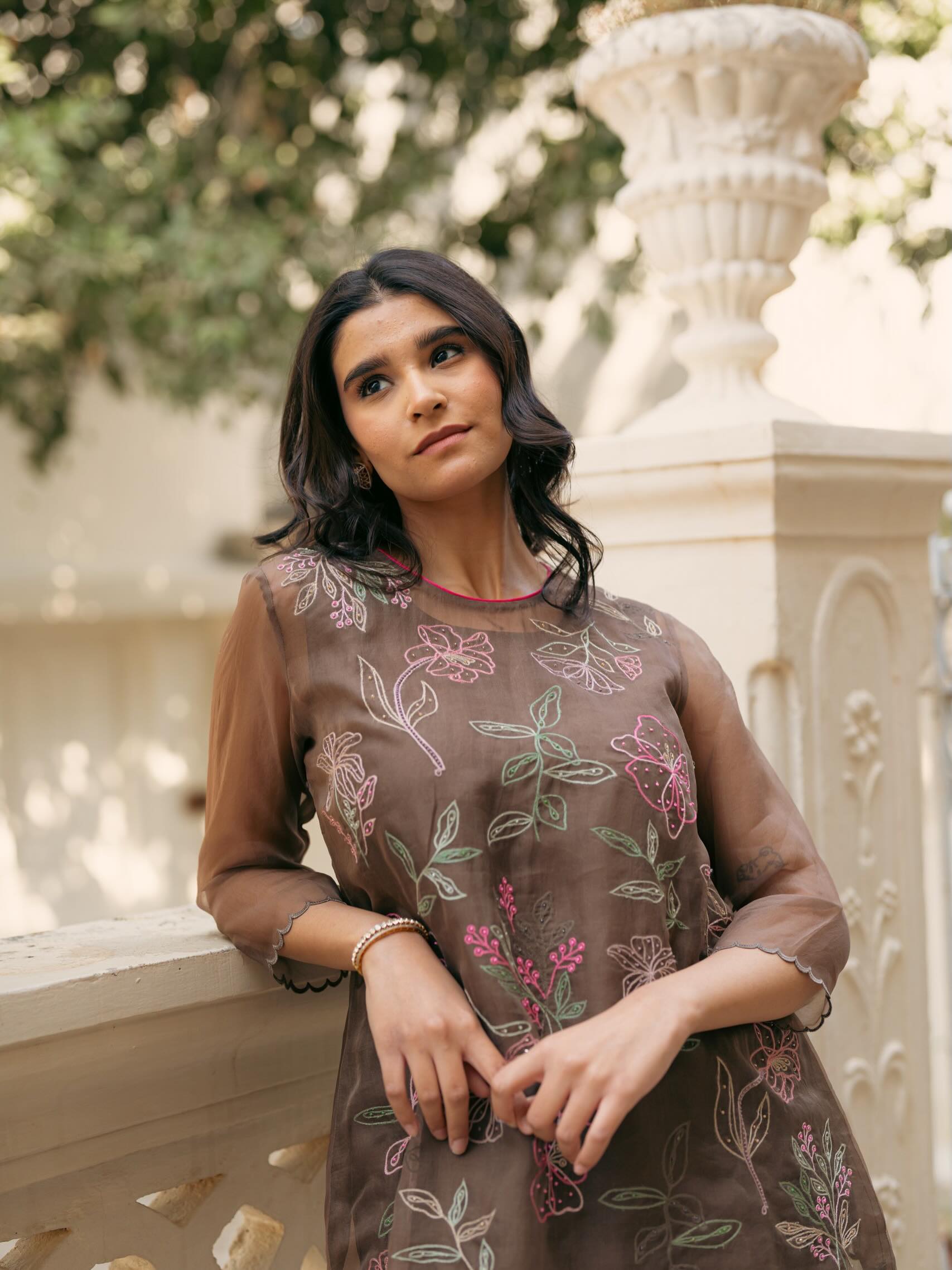 Soft florals and leaves stitched with care, warm tones that glow 