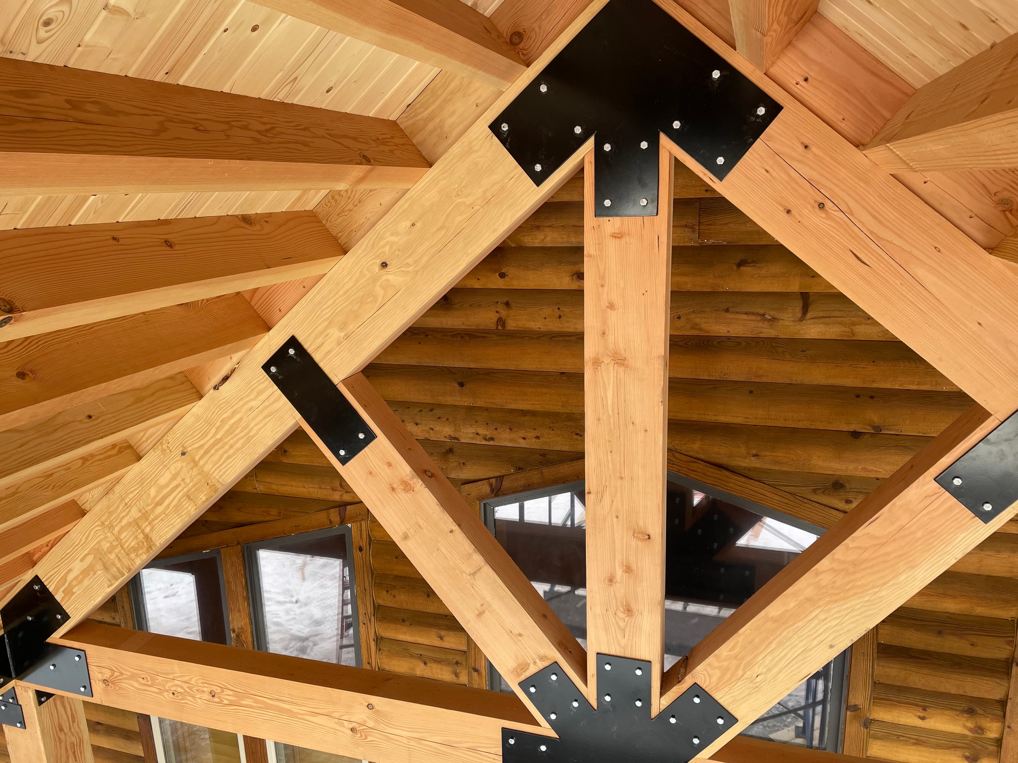 Moab LLC - Installing some of the timber frame brackets as...