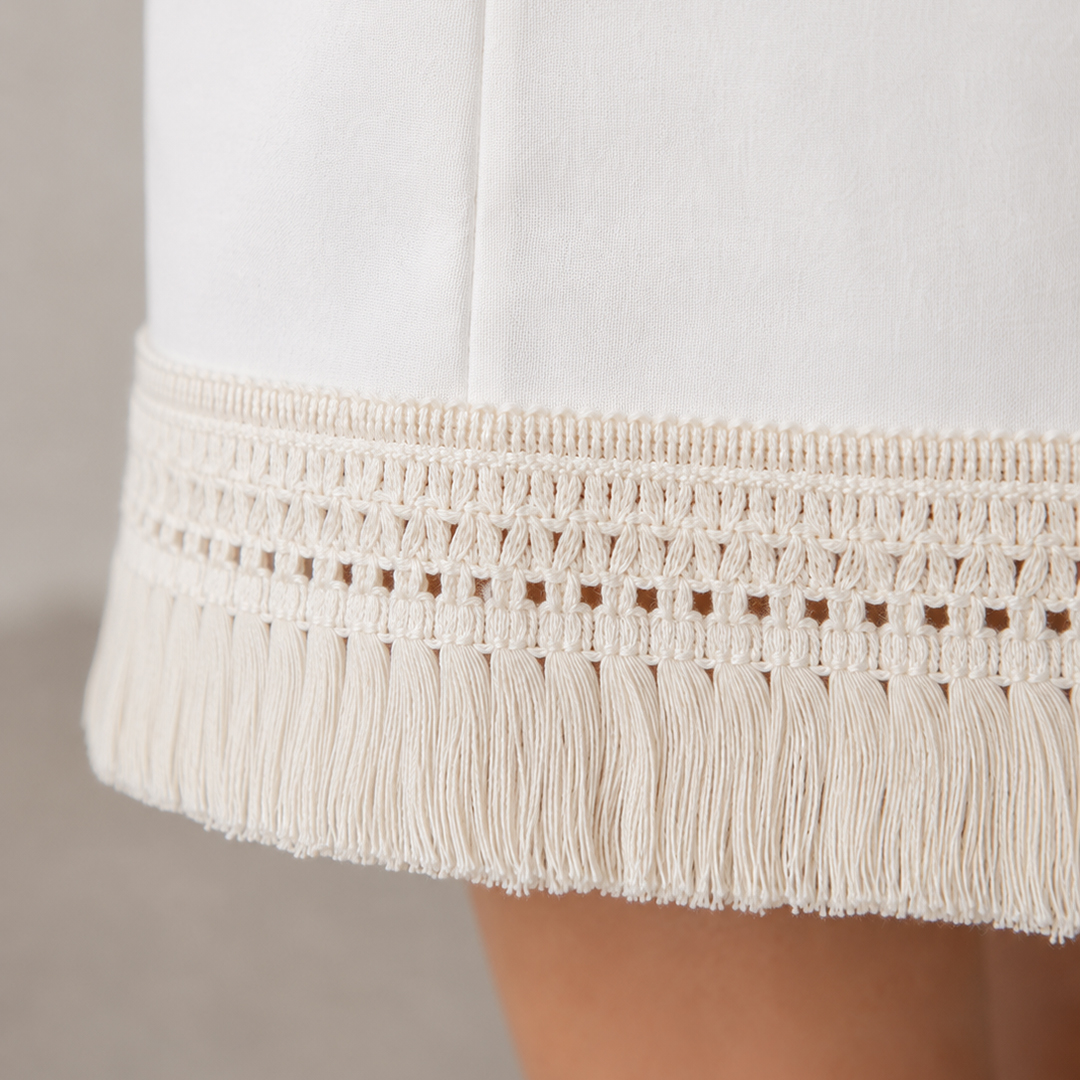 By adding a cotton fringe to a plain hem, you can upcycle a dress or skirt (or even a shirt sleeve) to an elegantly epic level!