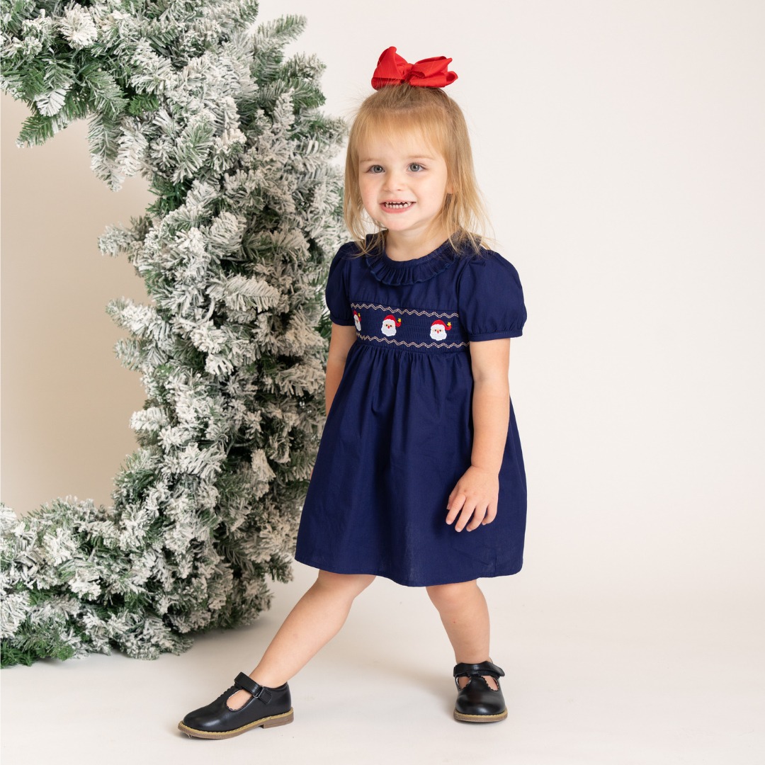 navy dress holiday This smocked Santa is packed with charm—from the adorable embroidered Santas to the round ruffle neckline! 🎄🎅🏼 🛍️ Shop the SANTAmental look now before it's gone! https://marienicoleclothing.com/products/navy-smocked-santa Product ID:AP1E211902_AB411_M