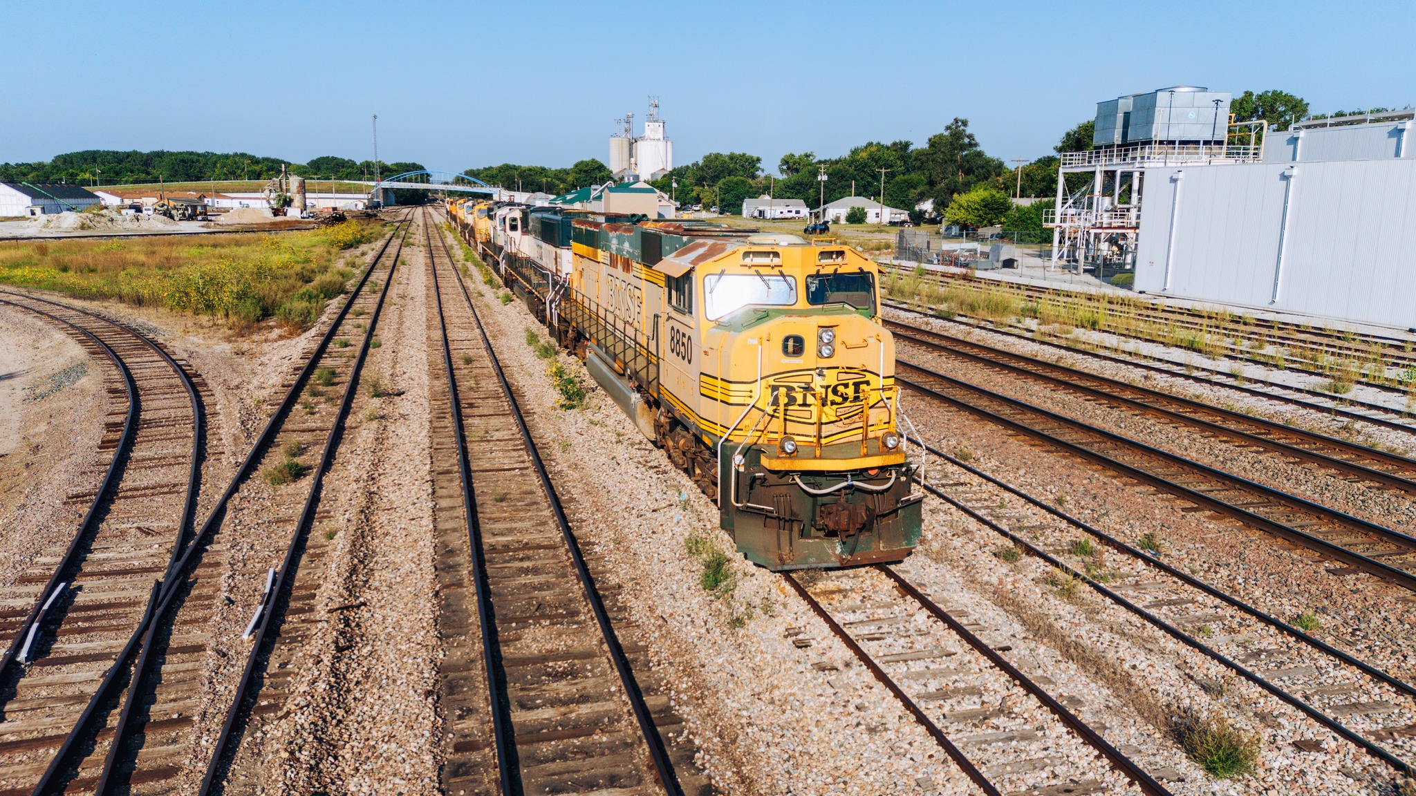 A string of dead SD70MAC's bask in the morning sun on a yard track