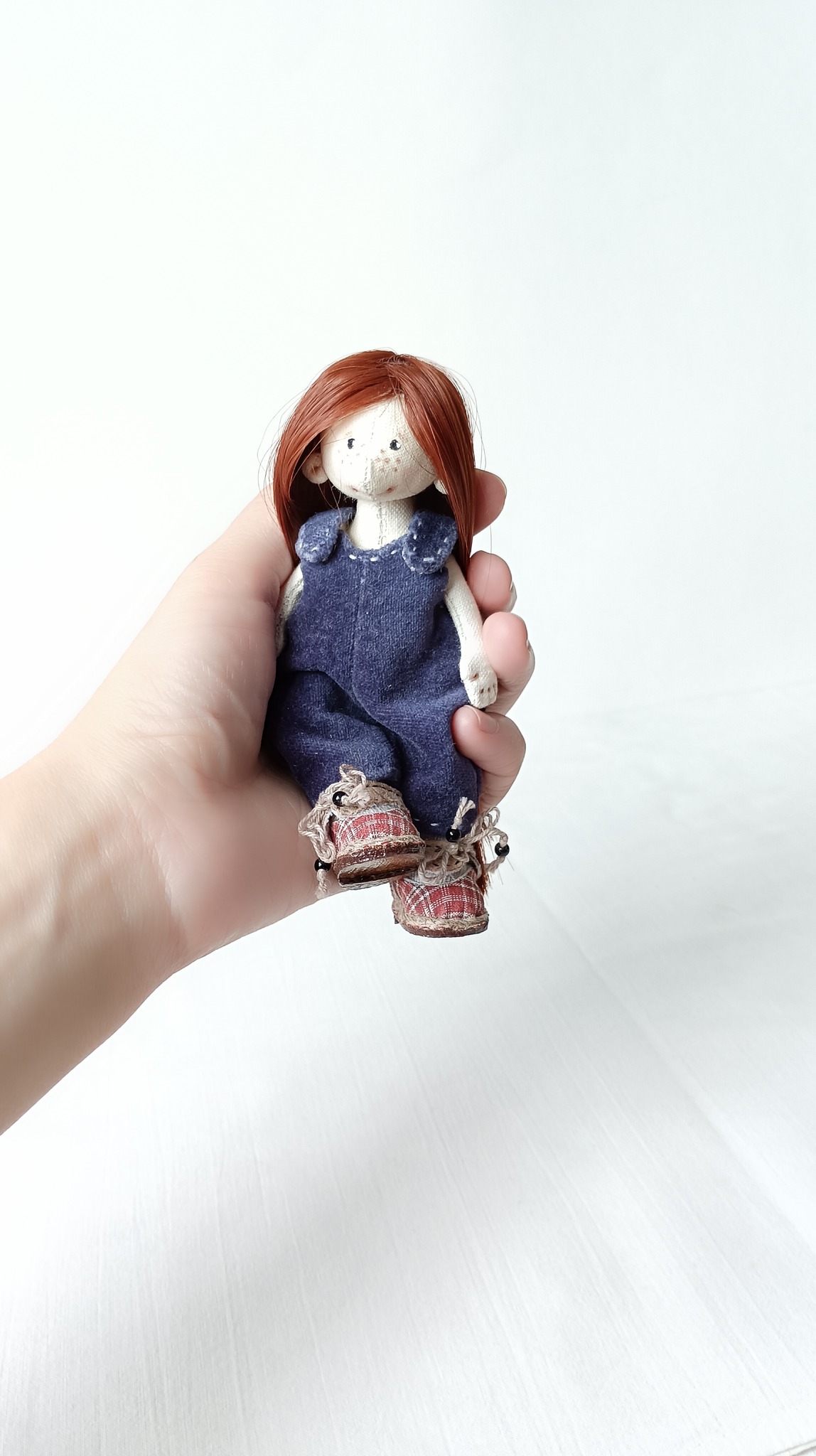 Adorable handmade OOAK doll with curious expression unveiled