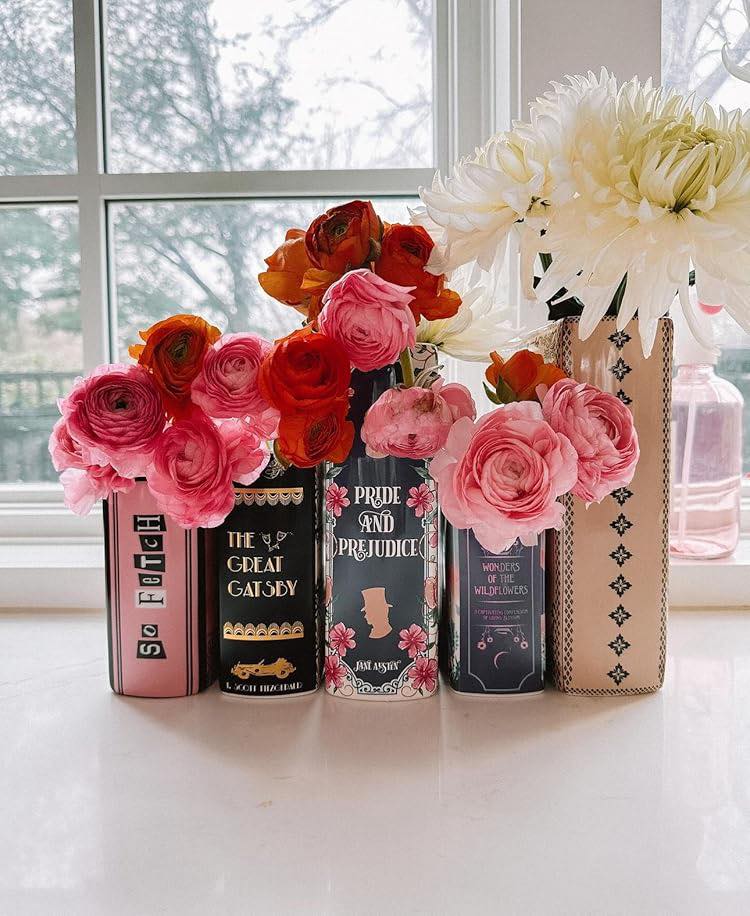 These are actual vases that you can get on Amazon, but they would be really easy to DIY with real books, without actually destroying them. Just insert artificial flowers, stack them side-by-side