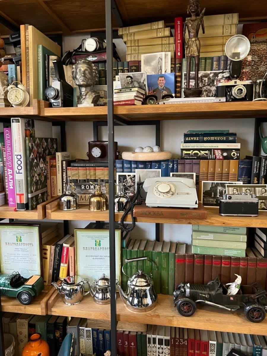 A collector's shelf in the truest sense—books mingling with old