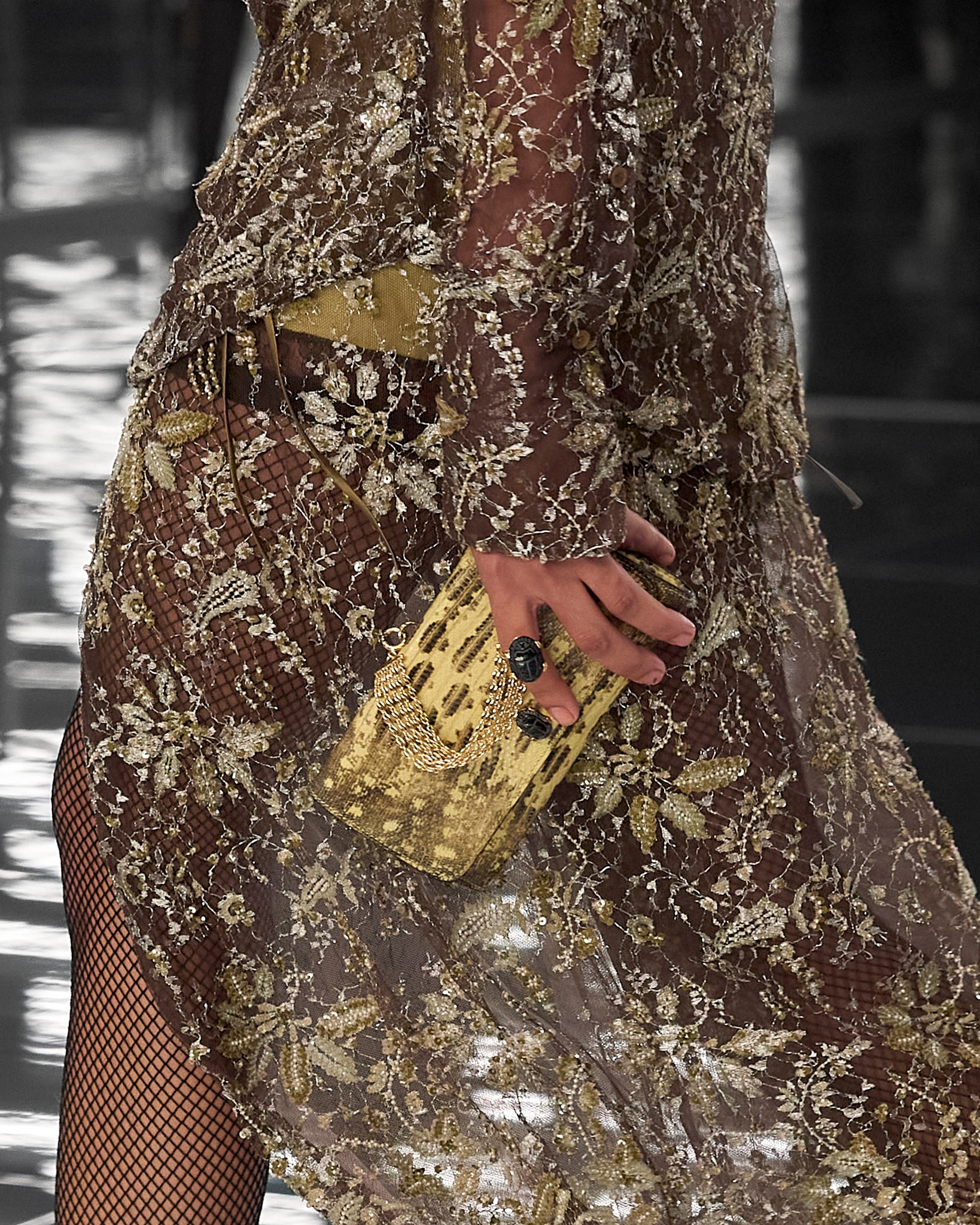 fendi gold lurex dress unveils its Spring/Summer 2027 collection by Maria Grazia Chiuri. On the runway, the mirror becomes a solid presence, forcing spectators into confrontation and into the discovery of others in the reflected all_products