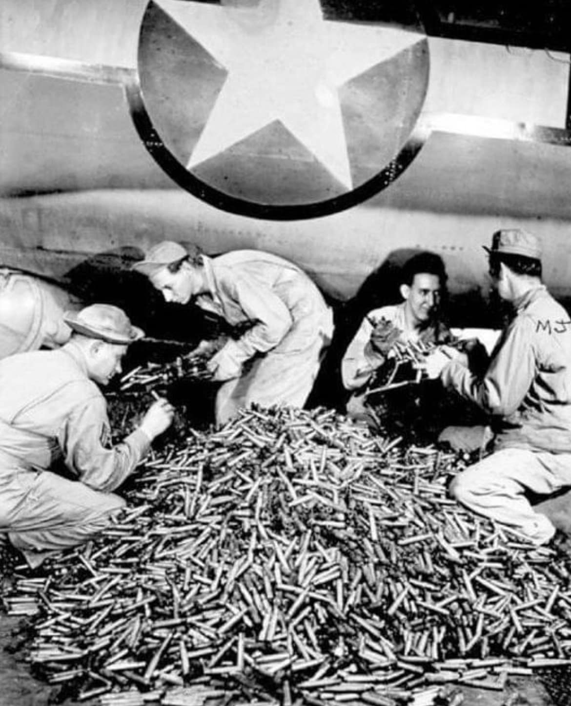 746th - 📸 Removing the spent shell casings from a B-17 after a ...