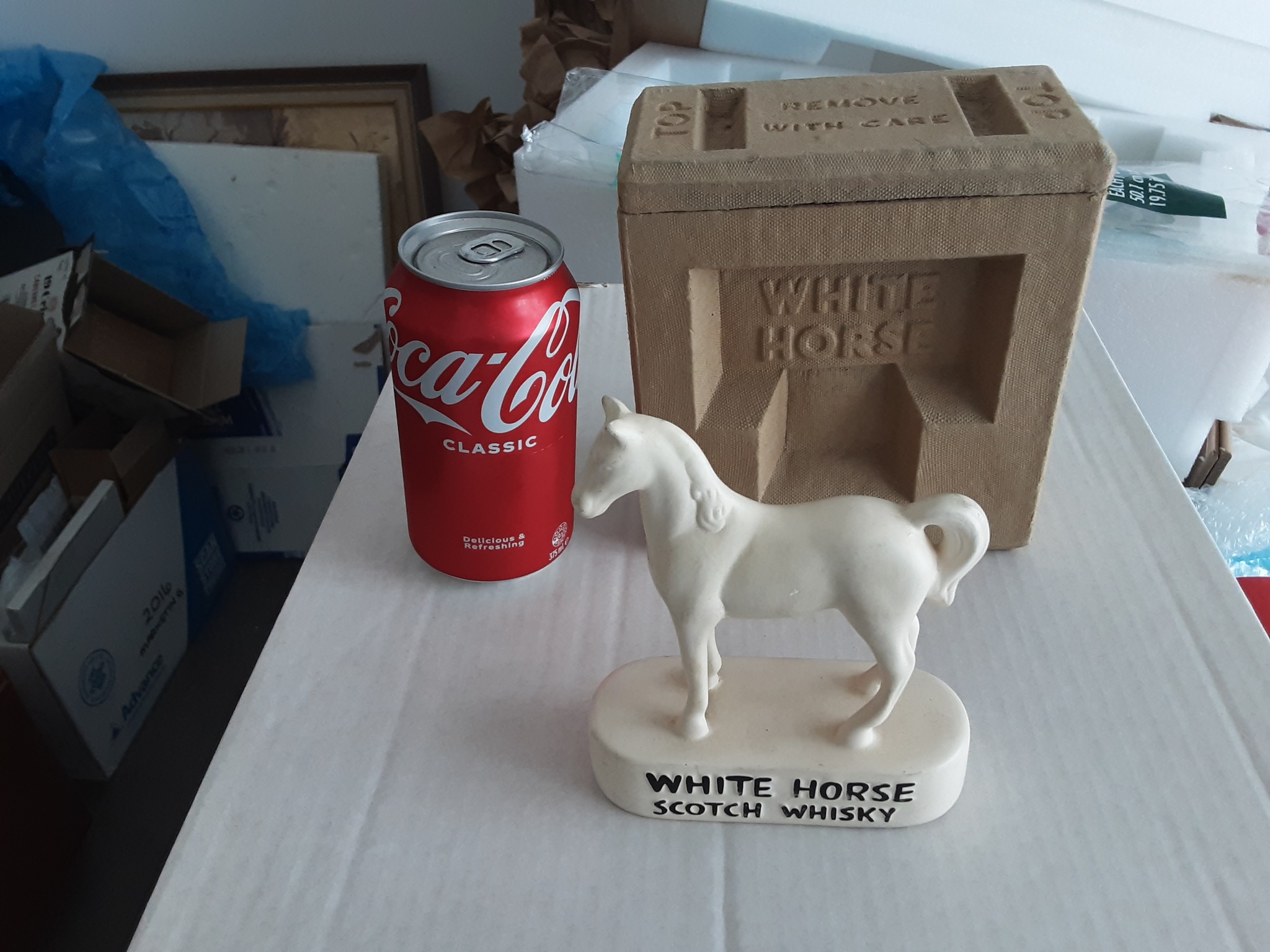 A rare early original collectible figure branded 'White Horse