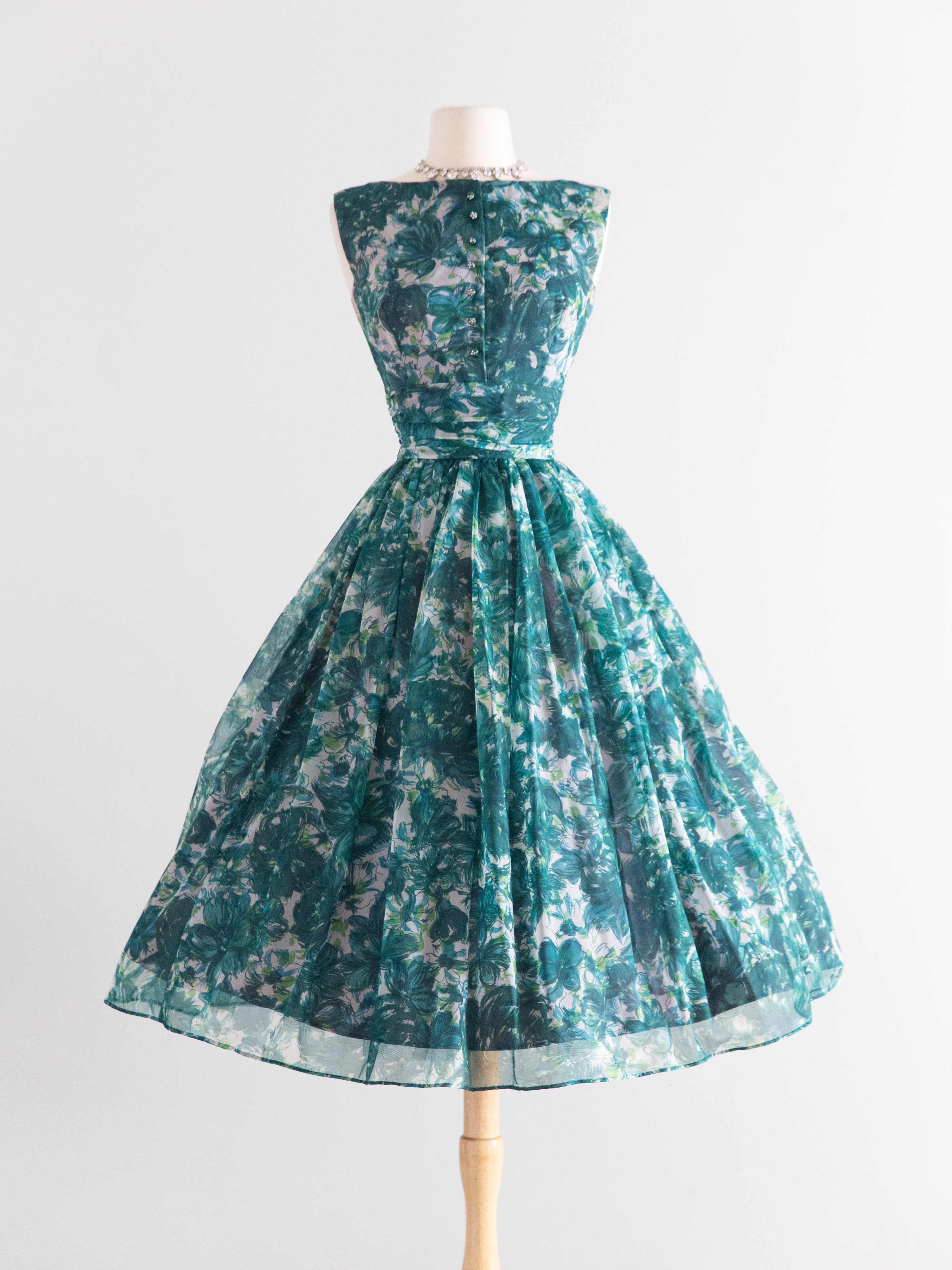 1950s green floral party dress with crinoline and rhinestone buttons at Xtabay Vintage Clothing Boutique