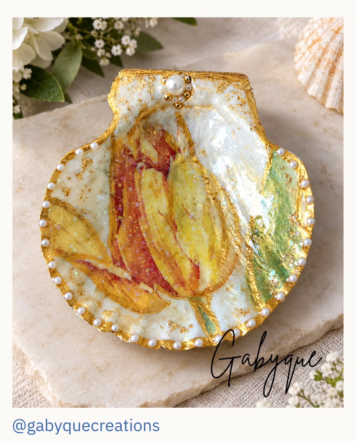 Hand-decorated scallop shell featuring vibrant florals, shimmering