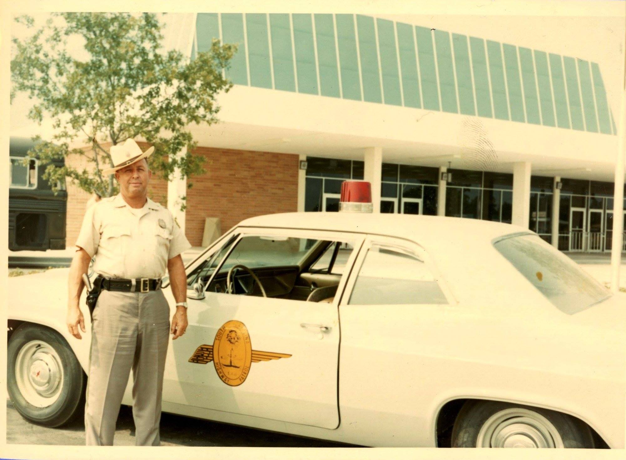 SCHP Patrolman Roy O. Caffey standing beside his 1966 Chevrolet