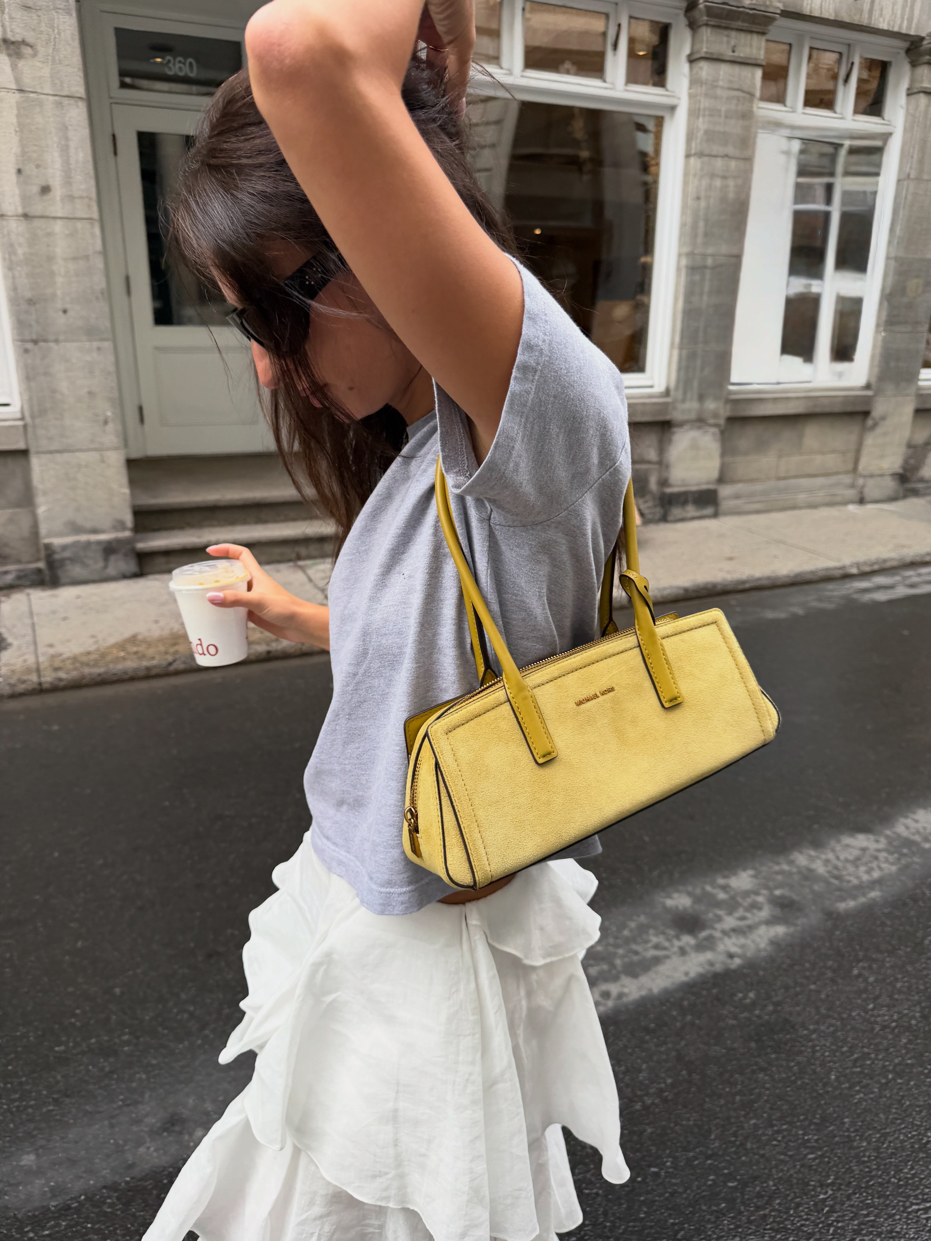 IzziPoopi sports our suede Laila shoulder bag in Montreal.