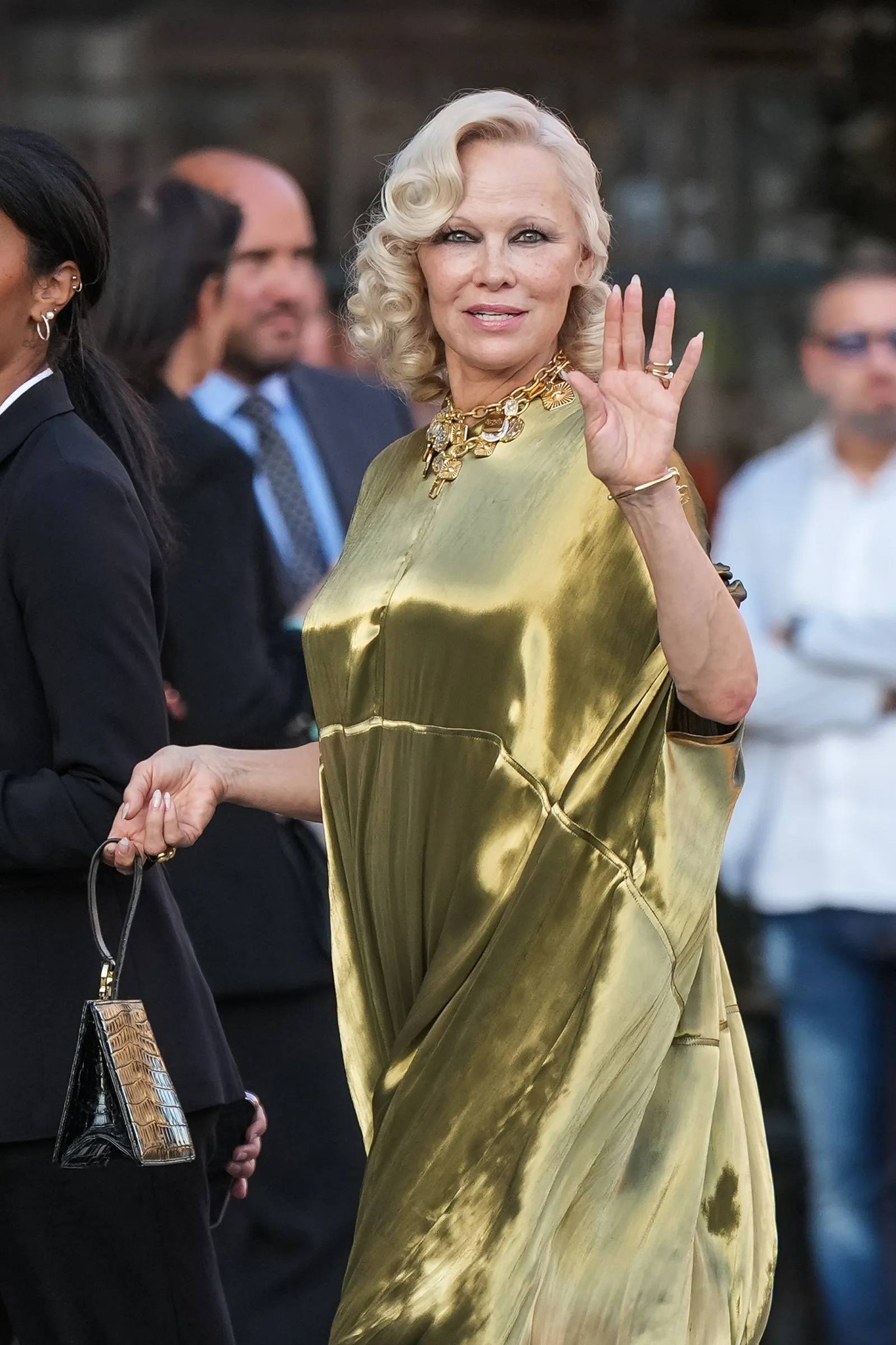 pamela anderson gold dress was pure glamour in at Vogue World: Milano, wearing a #Ferragamo Fall Winter 2026 look by Maximilian Davis. Gold was the right call. It caught the light of the speakeasy dress