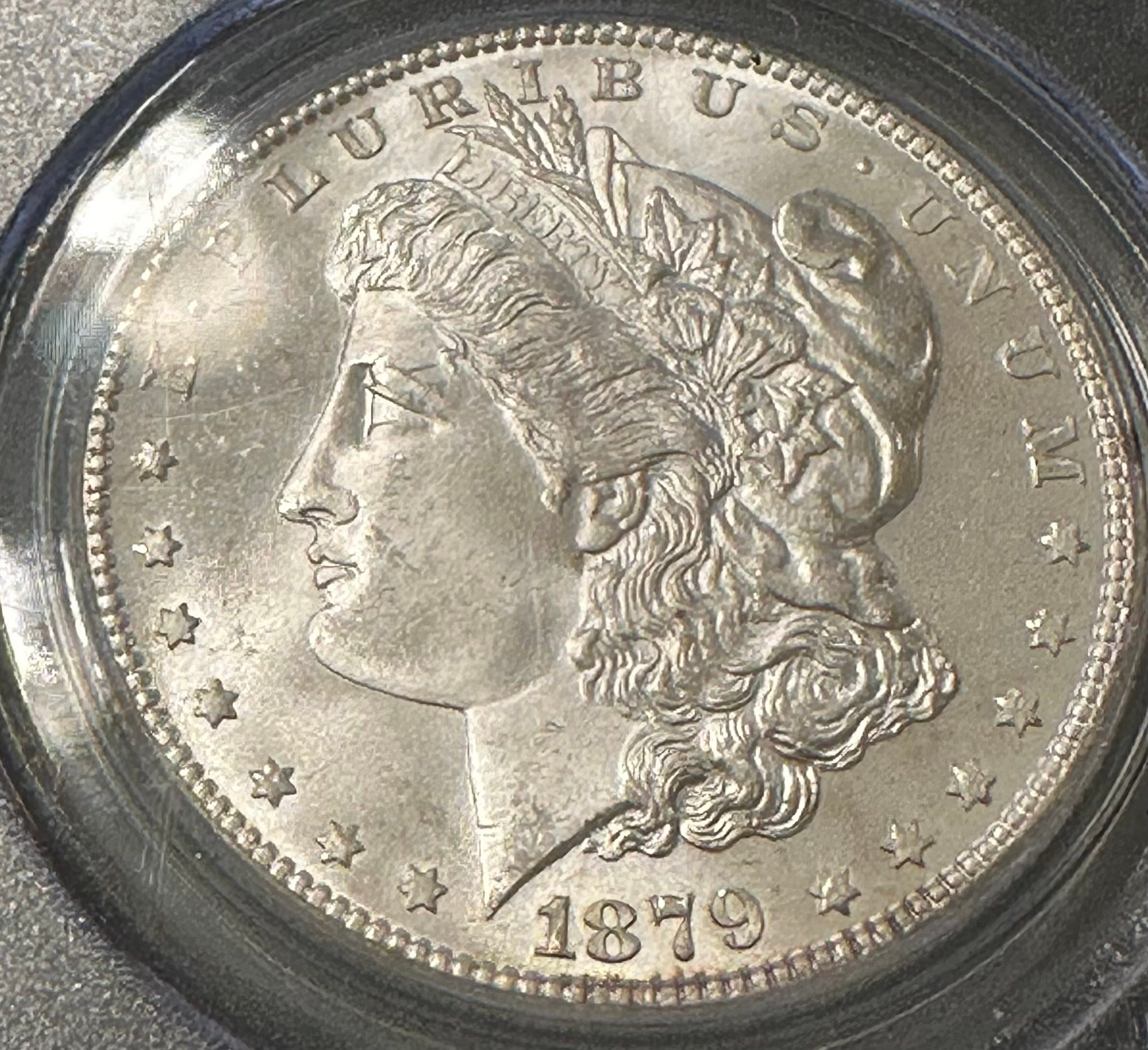 What is the grade of this 1879 Morgan Dollar coin?