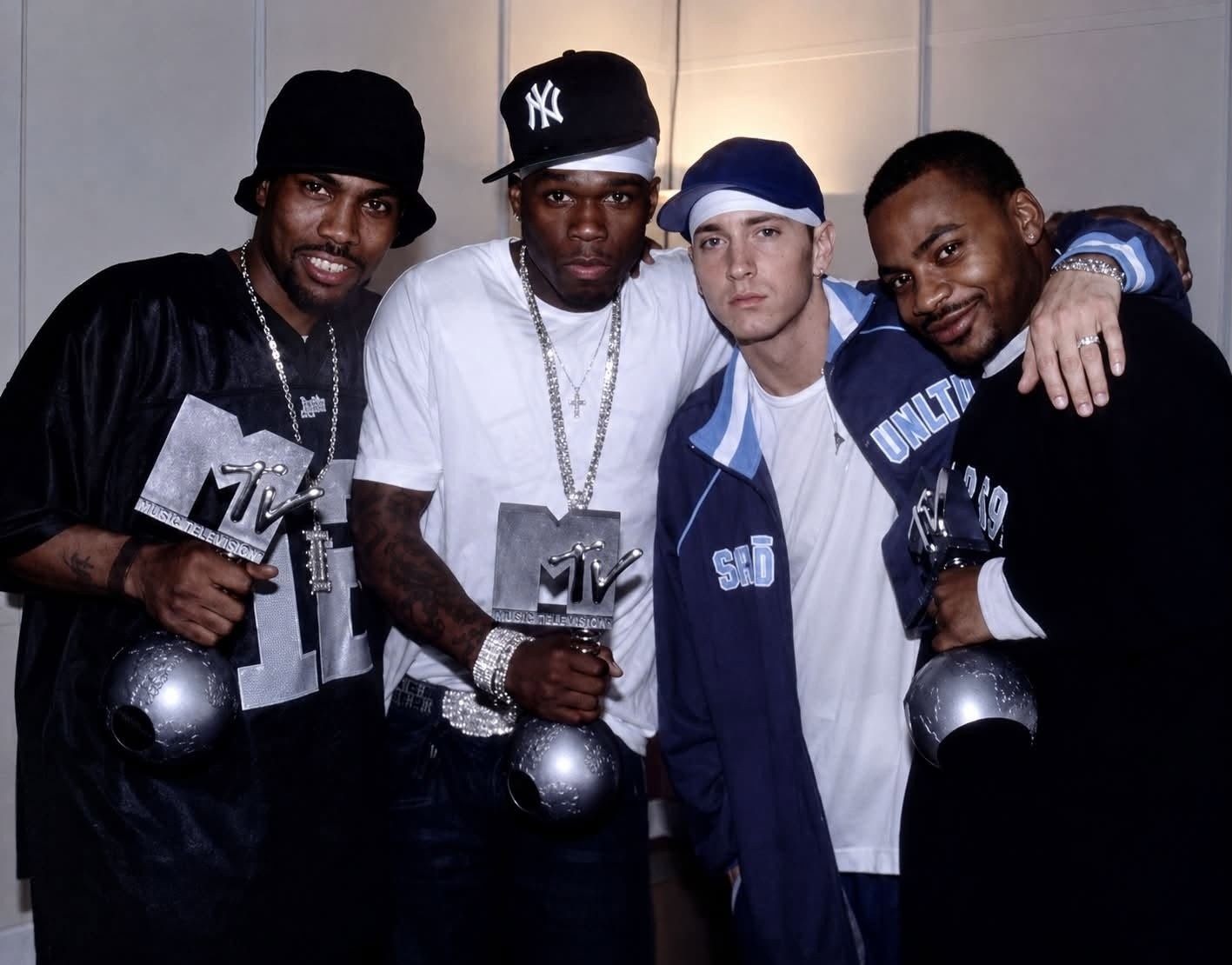 Proof, 50 Cent, Eminem, & Obie Trice pictured holding MTV Music