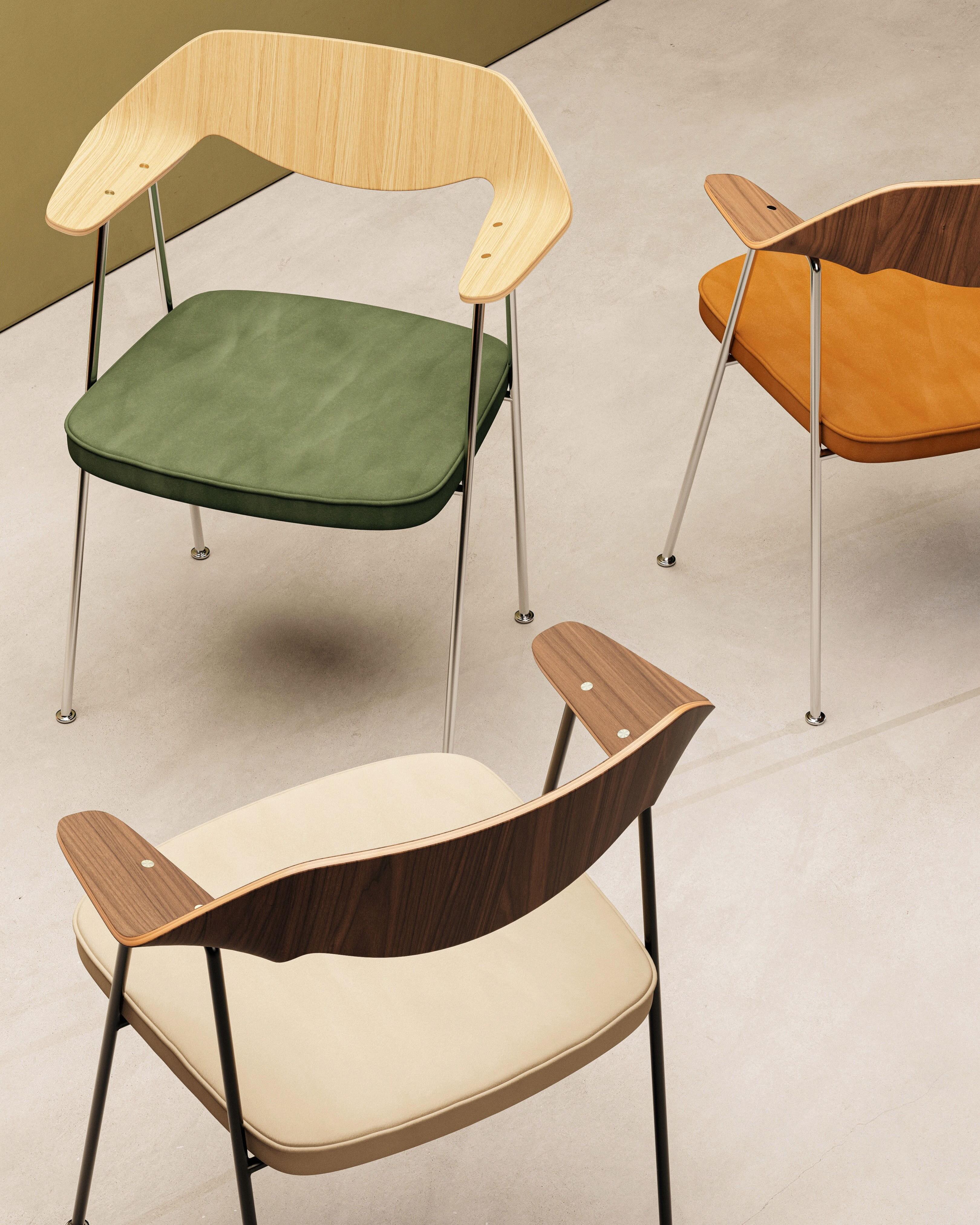 Case - 675 Chair designed by Robin Day made by Case Furniture sits