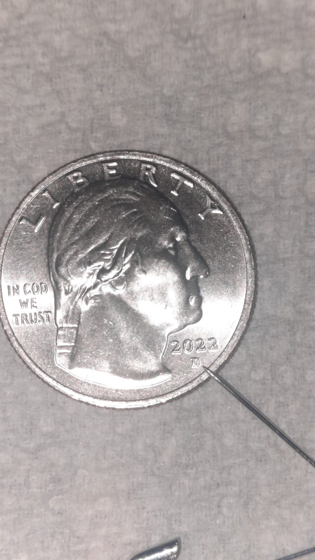 What do the letters and numbers on coins signify?