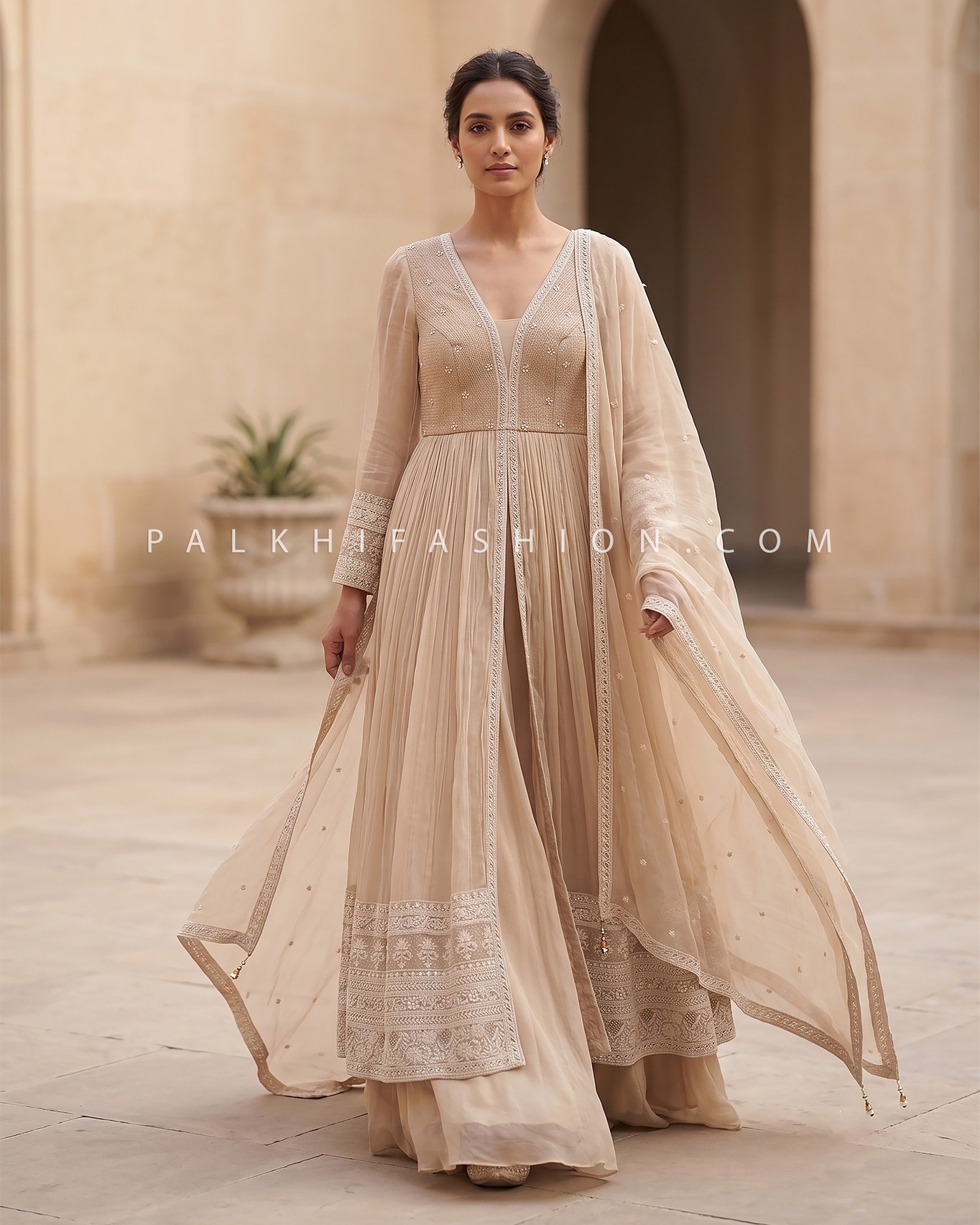 Looking for the perfect effortlessly graceful look for your upcoming Haldi or Destination Wedding? Your dream ivory ensemble is here. This elegantly structured front-slit Indo Western lehenga set perfectly blends understated luxury