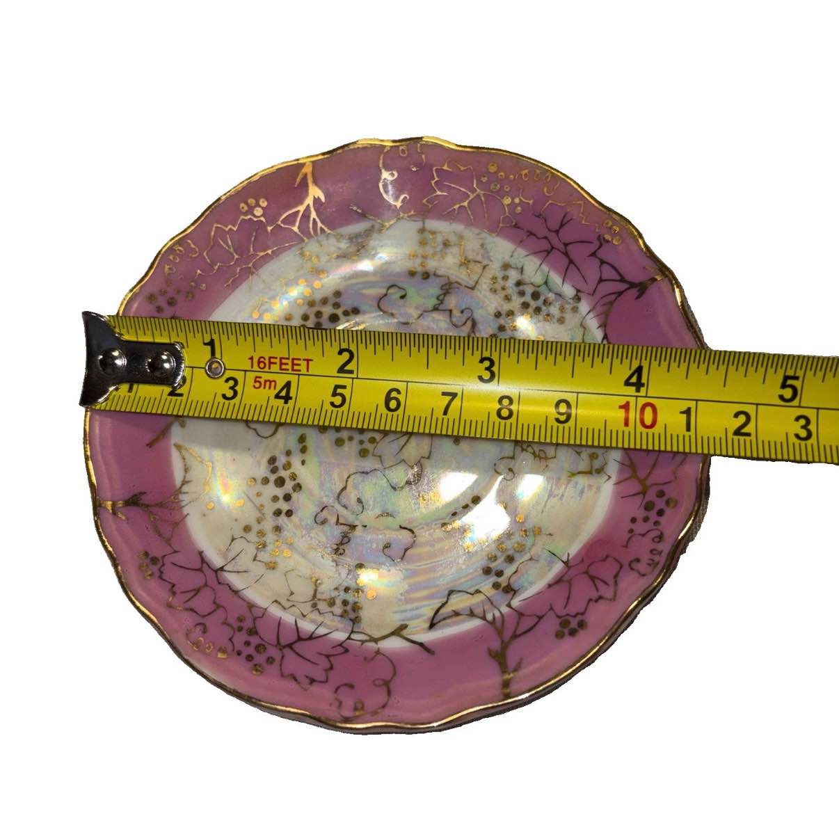 This vintage porcelain saucer from Japan exudes a nostalgic charm
