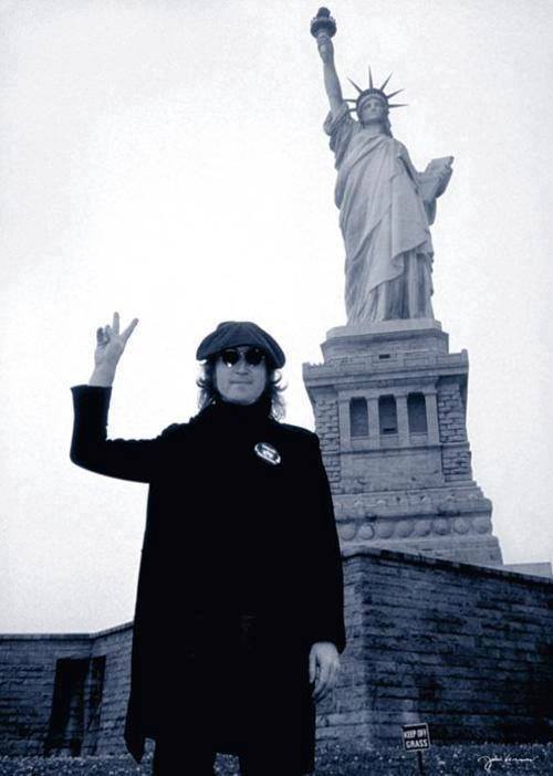 John Lennon with the Statue of Liberty, NYC, 1974. Photo by Bob Gruen