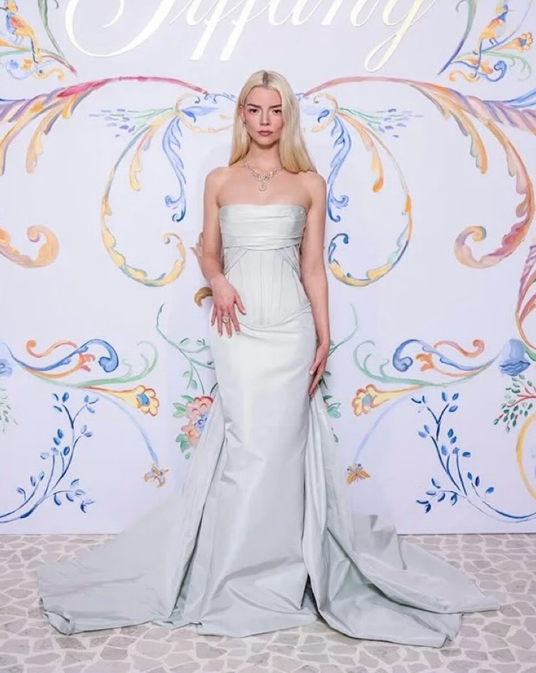 Anya Taylor-Joy wears a soft mint-green satin gown featuring a sculpted strapless corset bodice and a dramatic overskirt from the ZUHAIR MURAD Couture Spring 2026 Collection to Tiffany & Co's Blue Book “