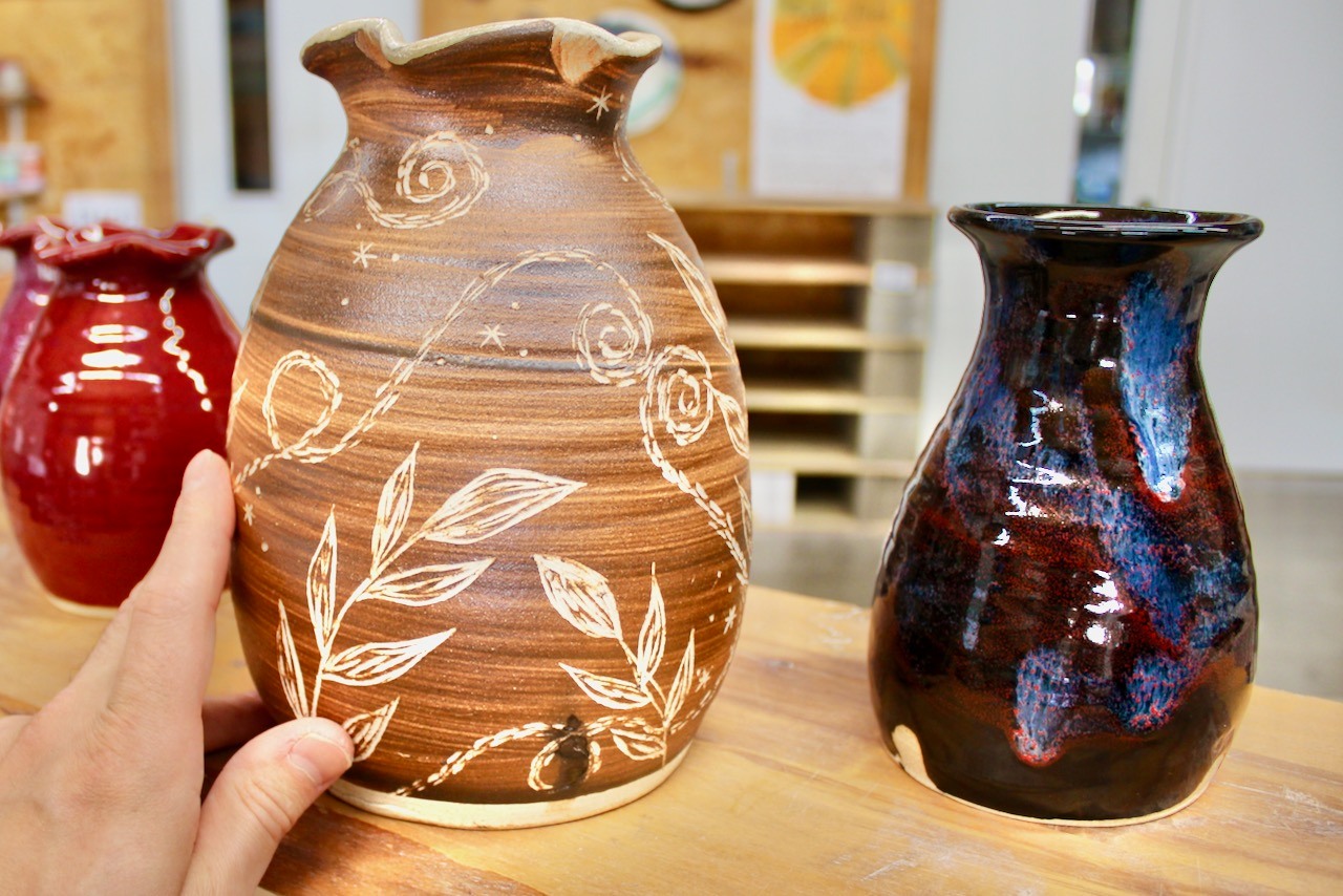 Carved vase, brushed with slip that we dug from our backyard. Thrown by me (Joel Cherrico) carved by Sienna Cherrico, included in our 