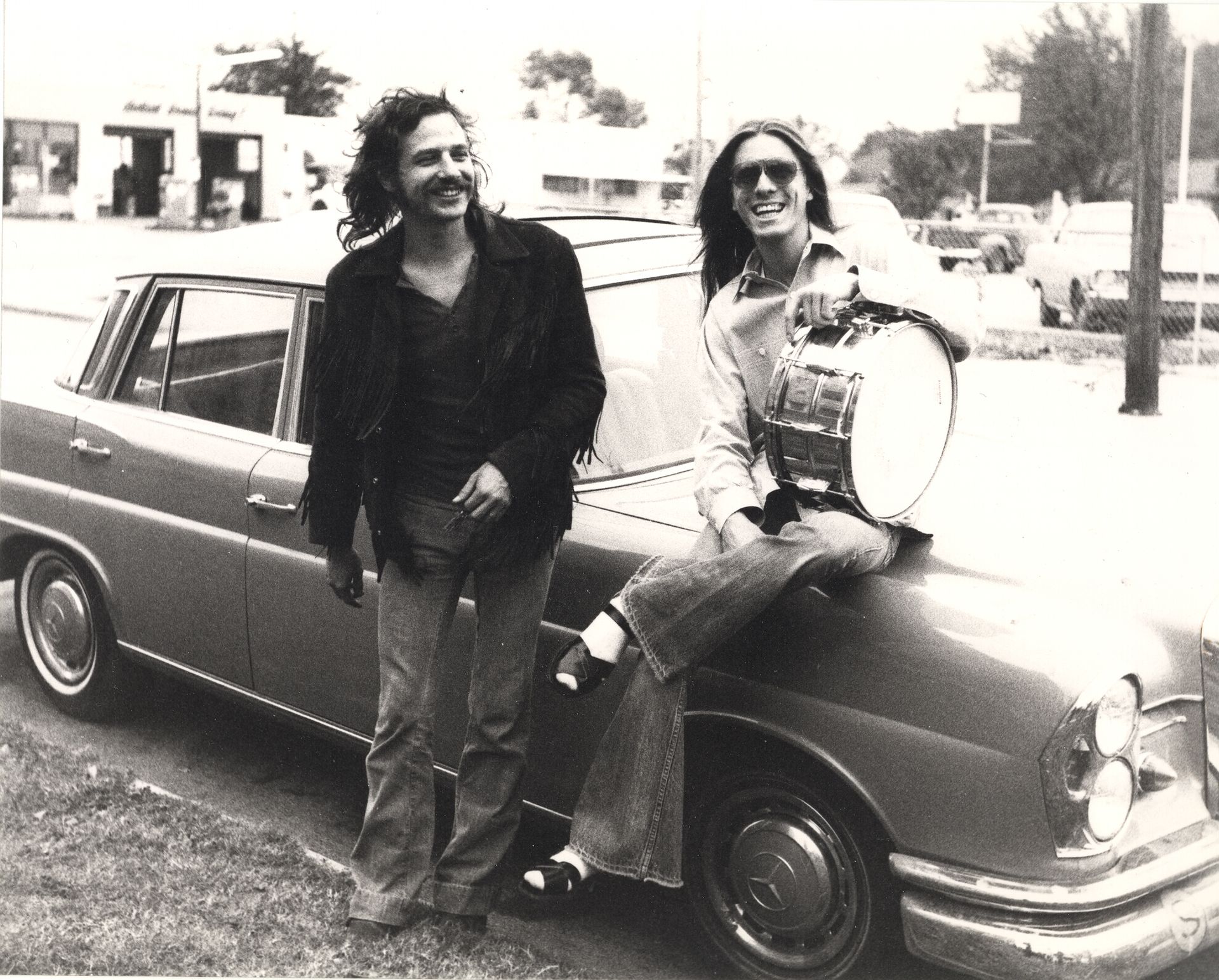 David Teegarden and Jamie Oldaker sitting on the Mercedes in front