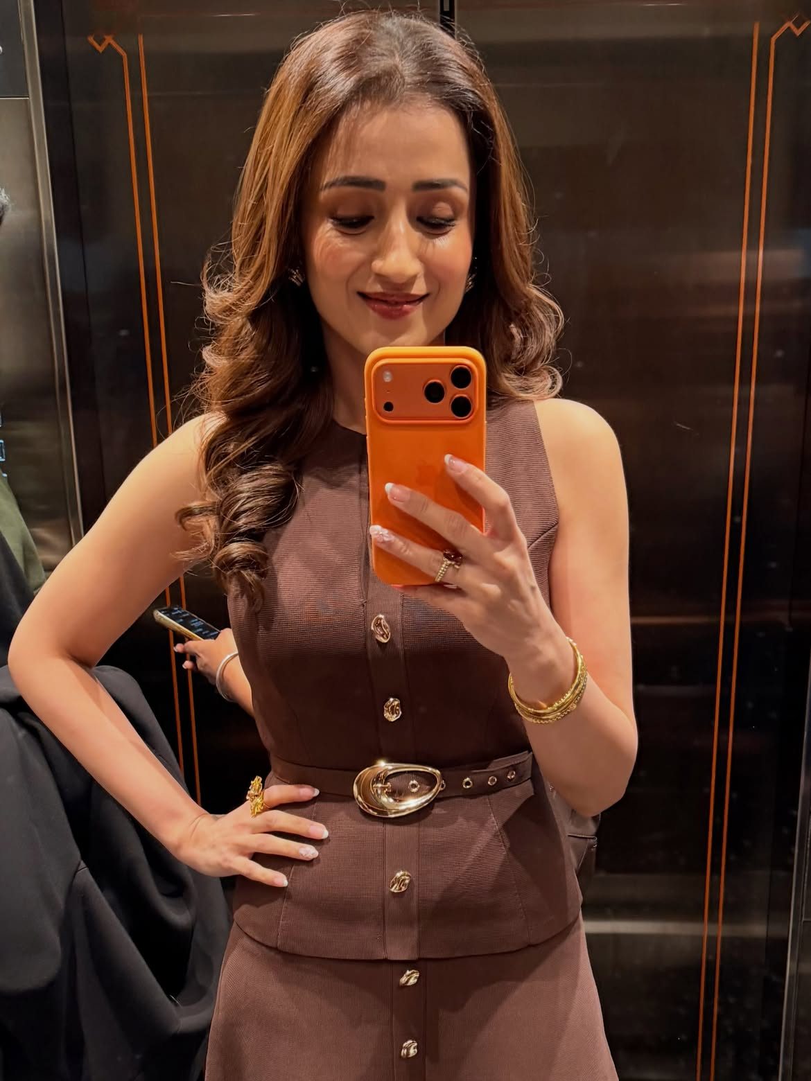 TrishaKrishnan stuns in this chic brown dress, showcasing her unique style. #FashionInspo #MirrorSelfie #StyleGoals