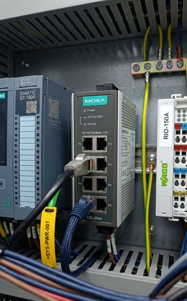 Can you identify the device located to the left of the MOXA switch?