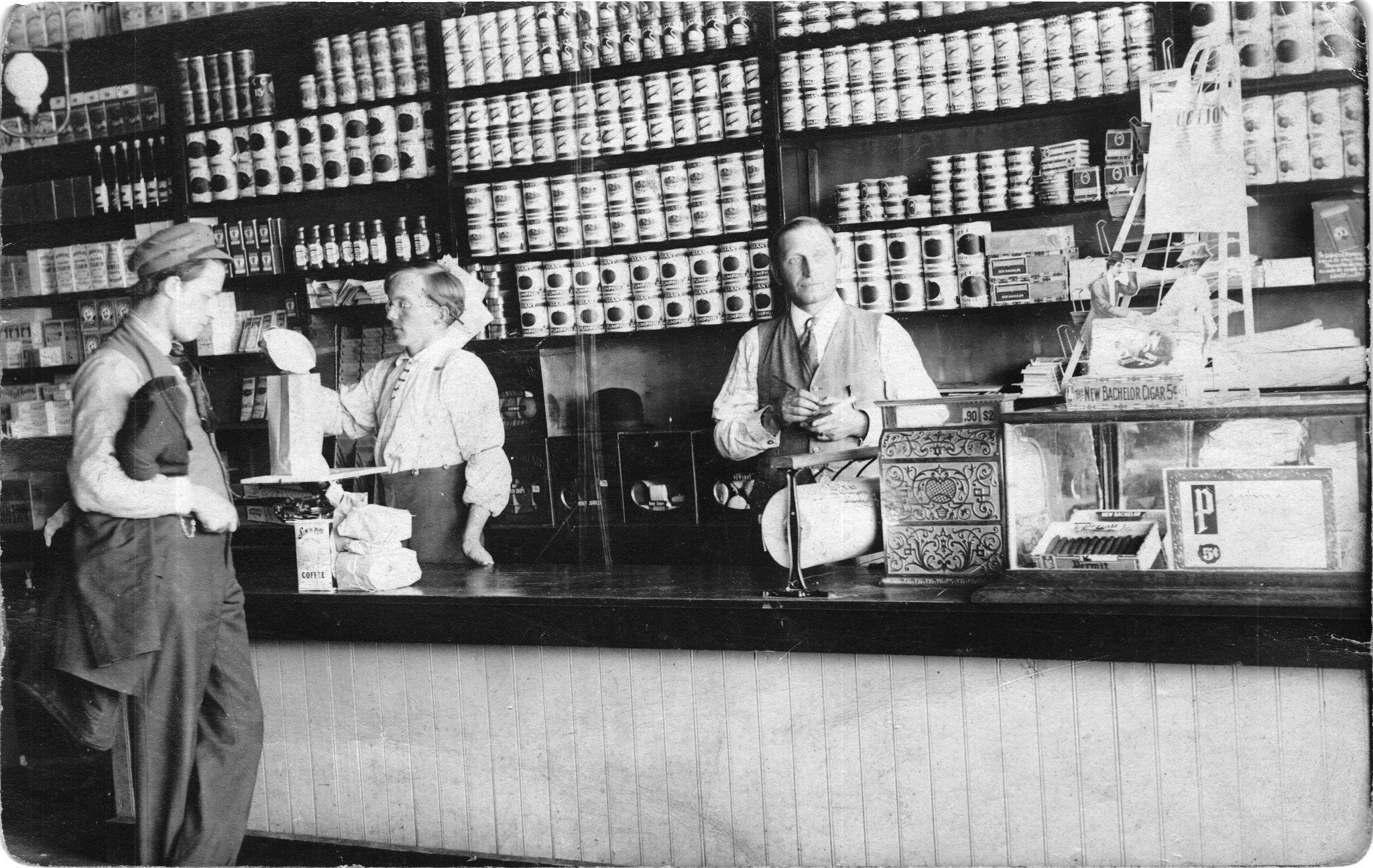 Beltrami - Clerk is adding something in a sack on scale.. Customer ...