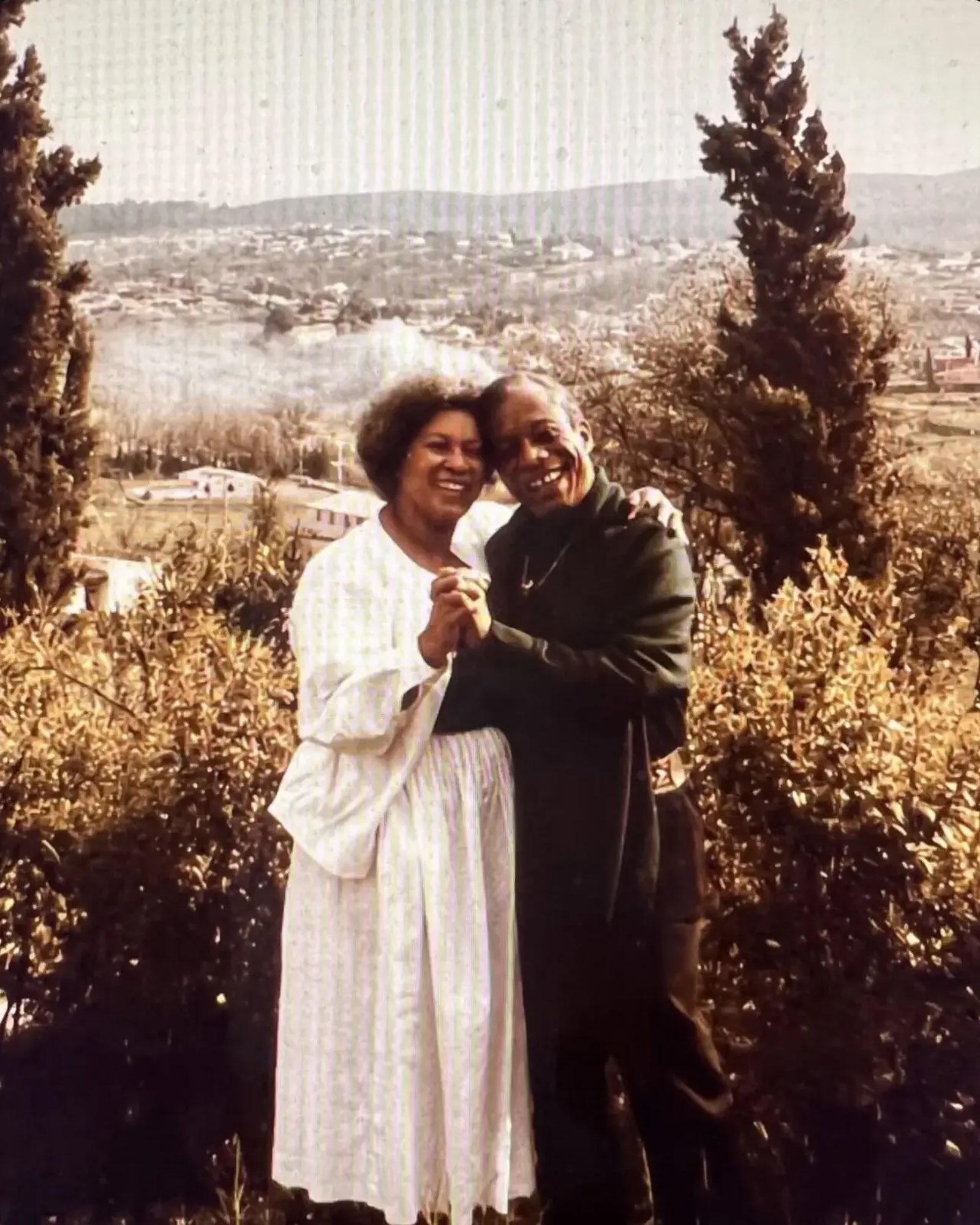 Toni Morrison and James Baldwin sharing a joyful embrace outdoors