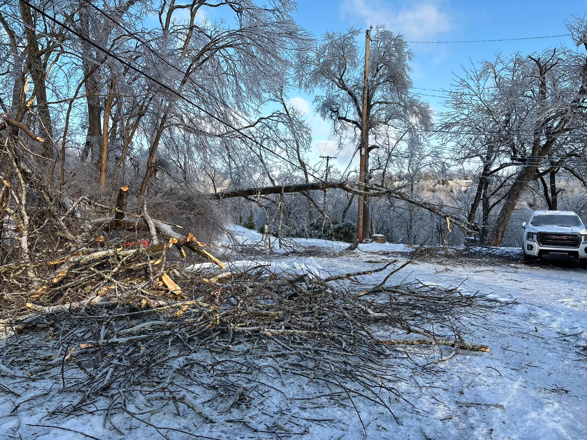 JPS, - Out here cutting away trees and limbs - fixing holes in roofs ...