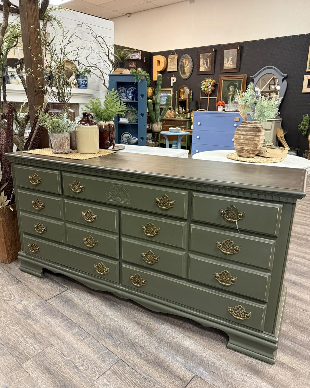 This long green dresser is such a beauty! The rich green finish paired with the dark wood top is the perfect combination, and it still has its original hardware to complete the