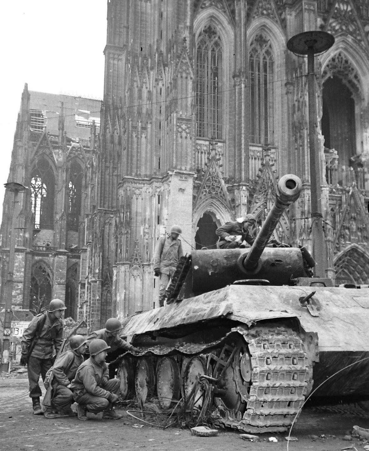 World - US 3rd Armored personnel look at 90mm shell holes in a ...