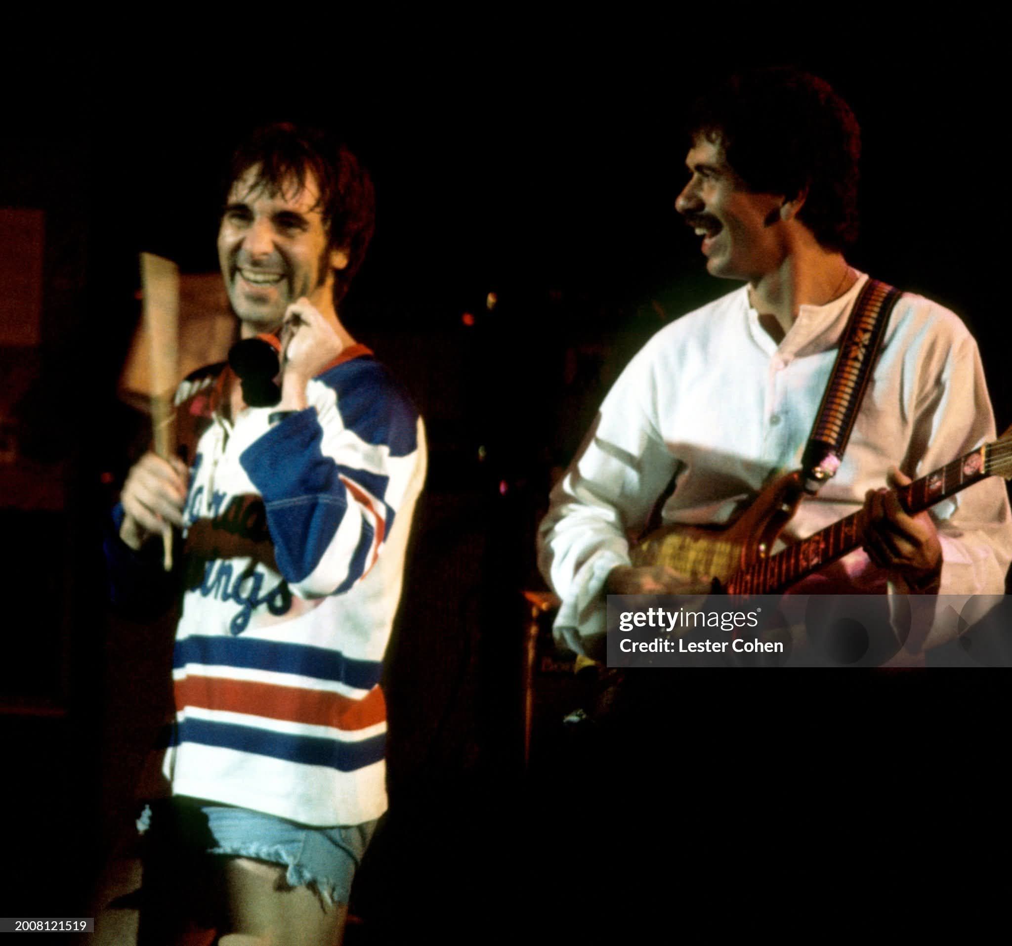 John appearing with Carlos Santana and Eric Clapton at the Nassau 