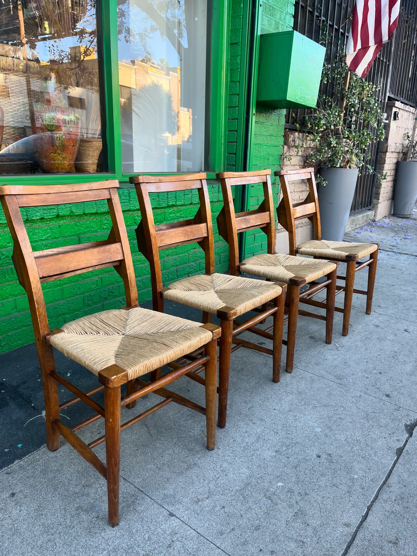 A set of four antique church chairs with rush seats and book 